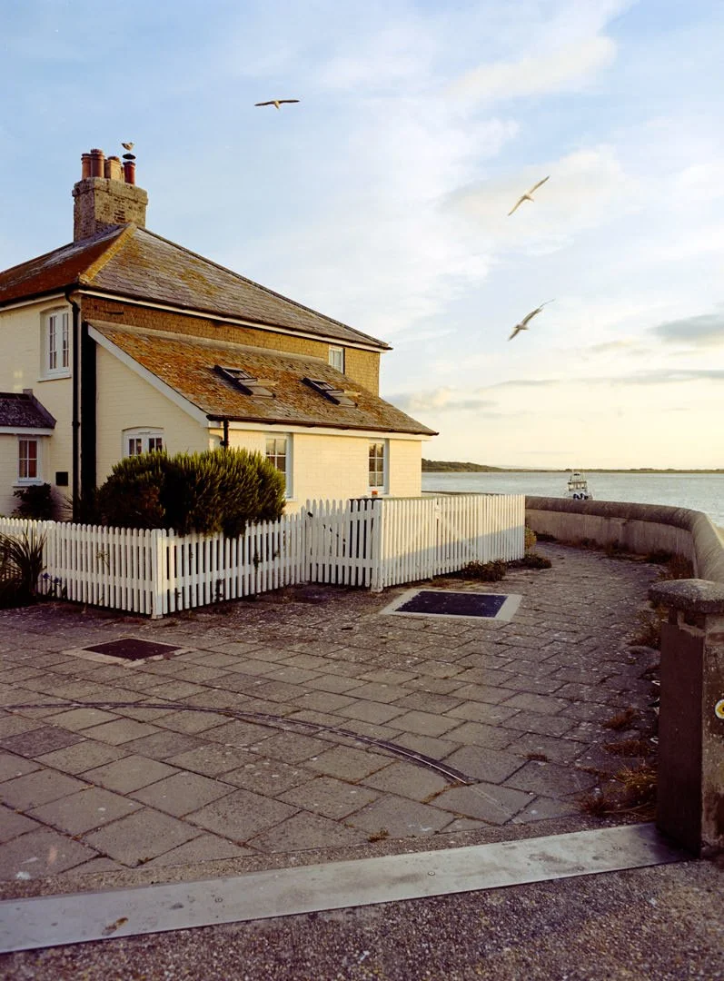 house next to sea during sunset with birds flying over roof, mudeford dorset, Kodak Portra 160 film