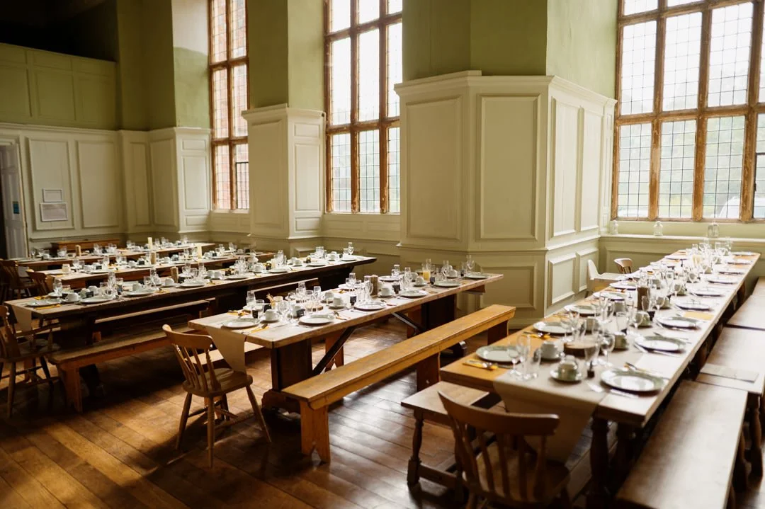 long wooden wedding tables with wine glasses and plates
