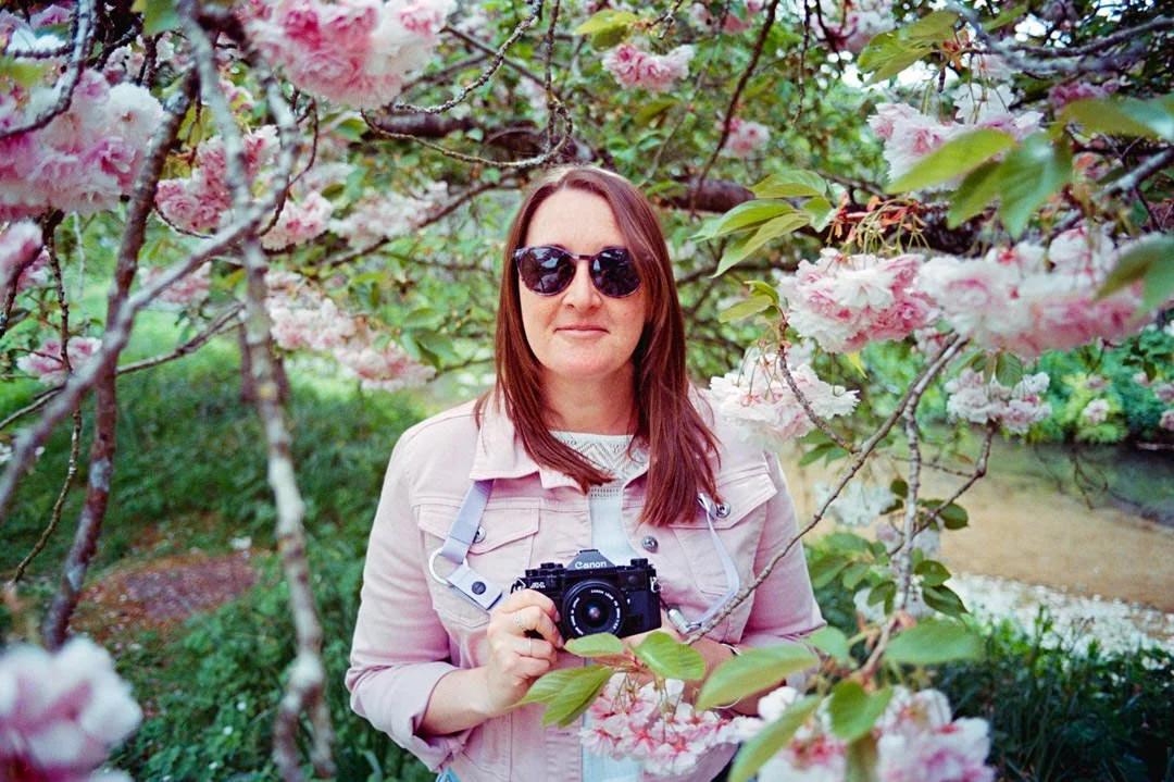 girl waring pink jacket holding canon a1 camera, Kodak ULTRAMAX