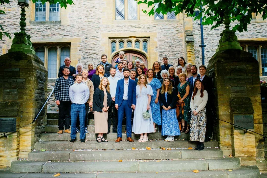 large group of people stood for photographs at wedding