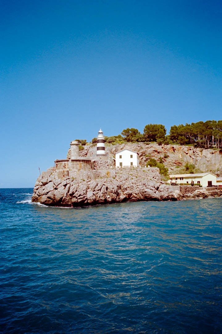 lighthouse on rocks with blue ocean Majorca