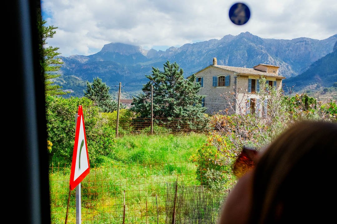 mountains and small houses out of coach window lemon tours