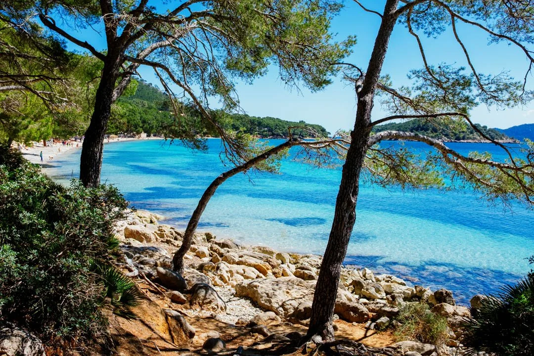 golden beach with blue water and mountains, formentor majorca