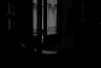 Dunkles Fenster in einem Raum bei Nacht