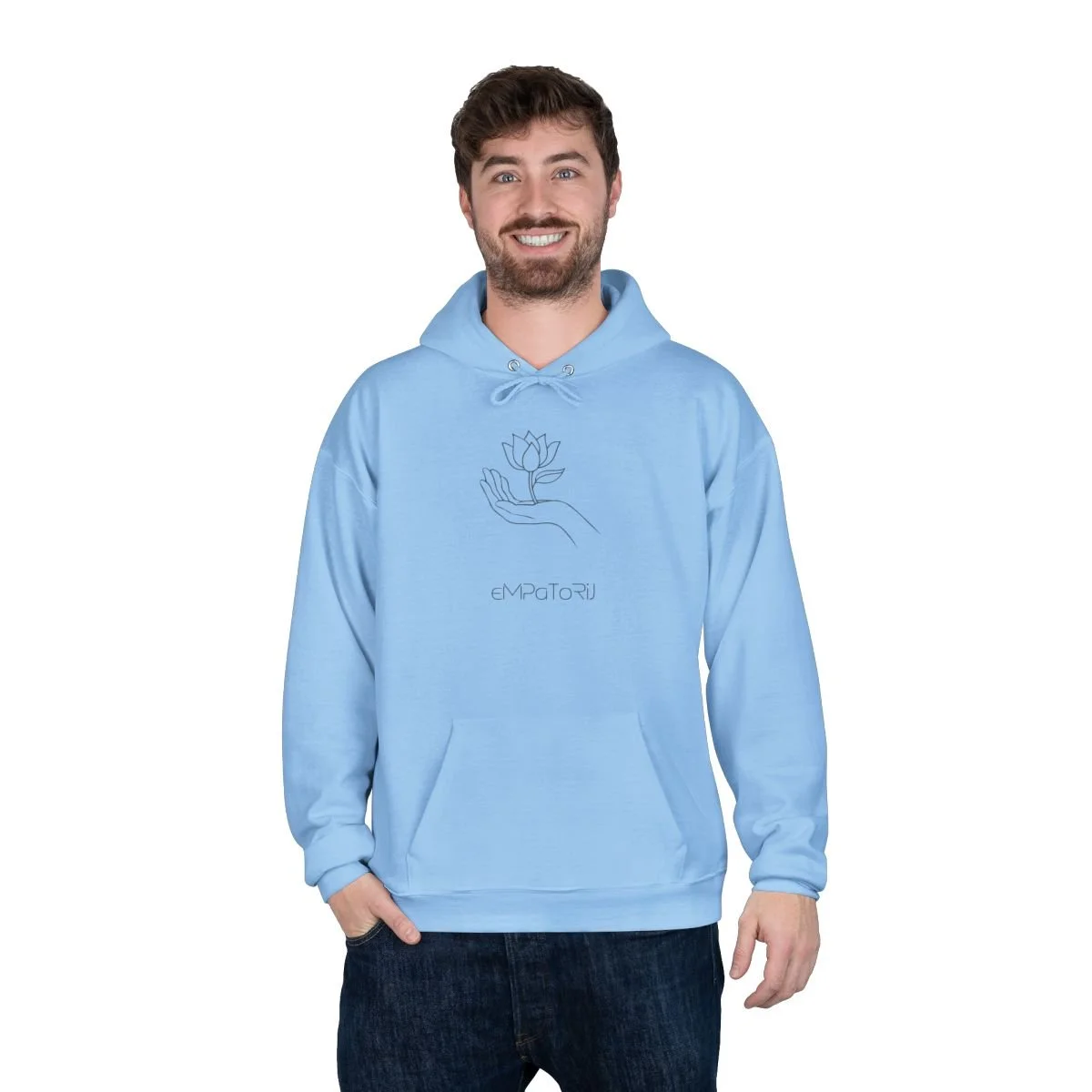 A smiling man wearing a light blue hoodie with a line drawing of a hand holding a flower and the word 'EMPATiR' printed underneath.