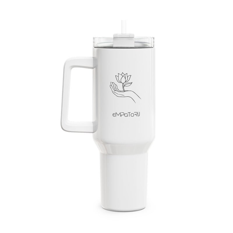 A white portable blender with a handle, a transparent lid, and a graphic of a hand holding a flower."Empath" is written upside down on the blender.