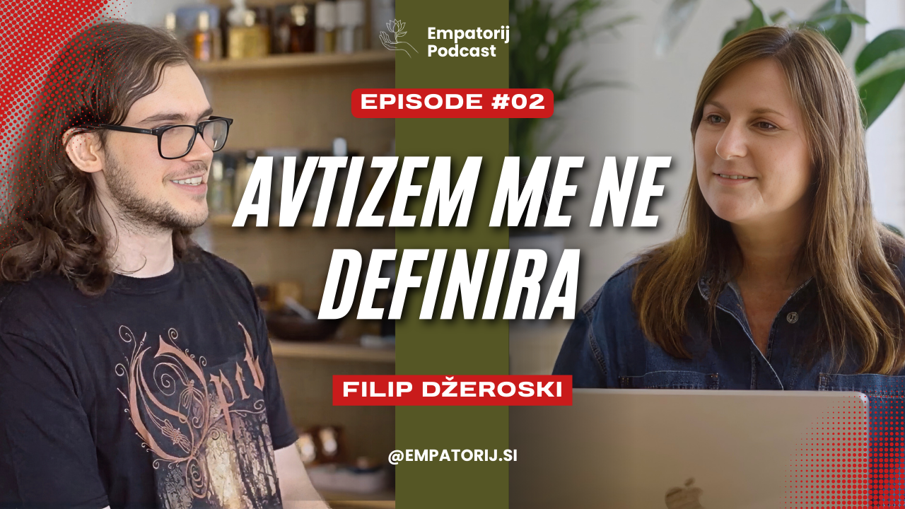 Two people sitting at a table in conversation, with a laptop in front of the woman on the right, and shelves with jars and bottles in the background.