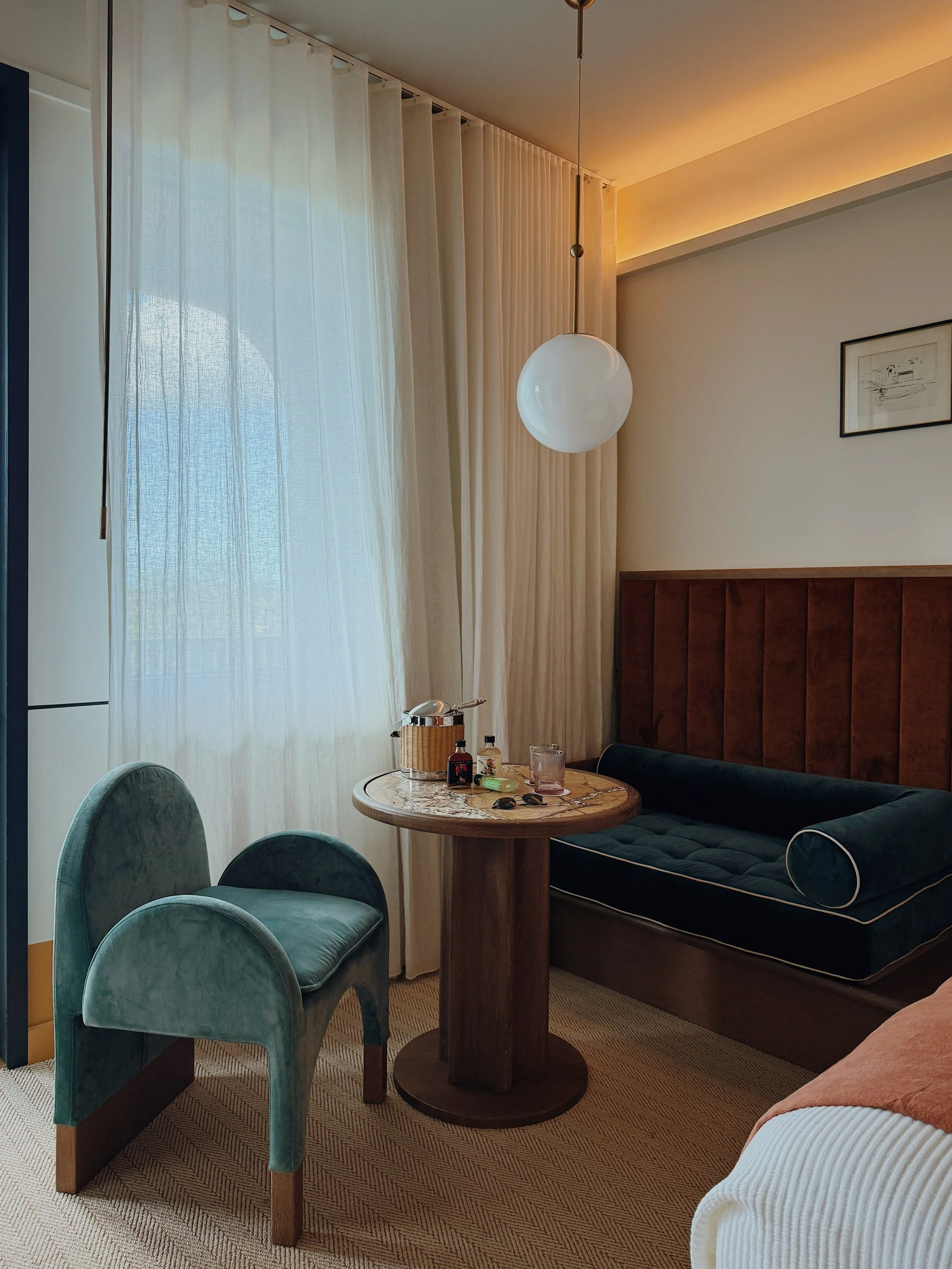 Seating area inside a suite at Hotel Henrietta in New Orleans with layered textures and soft natural light photographed by hospitality photographer Natalia Moreno.