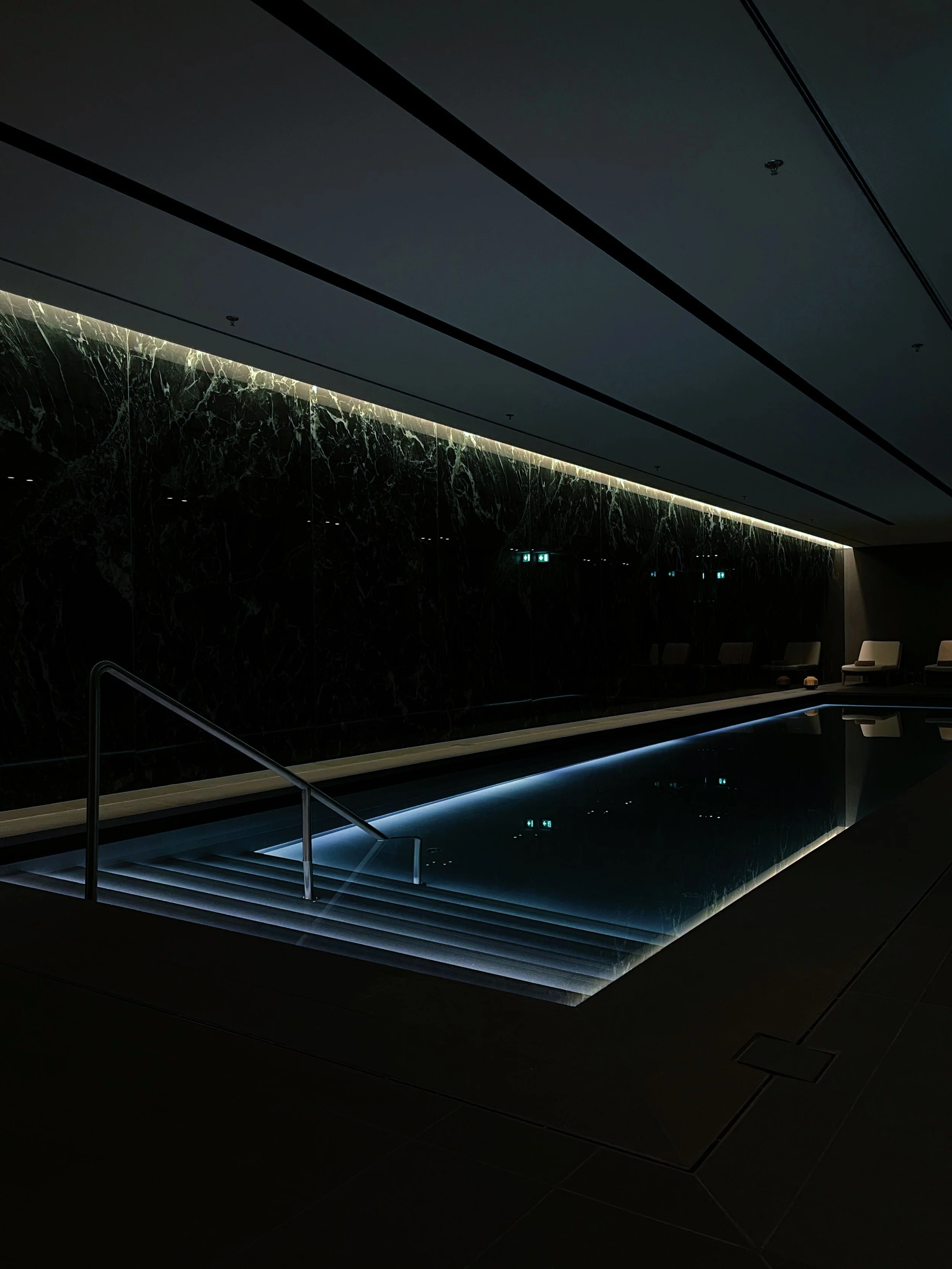 Indoor spa pool at Dorothea Hotel in Budapest featuring minimalist lighting and refined architectural lines photographed by architectural hotel photographer Natalia Moreno.