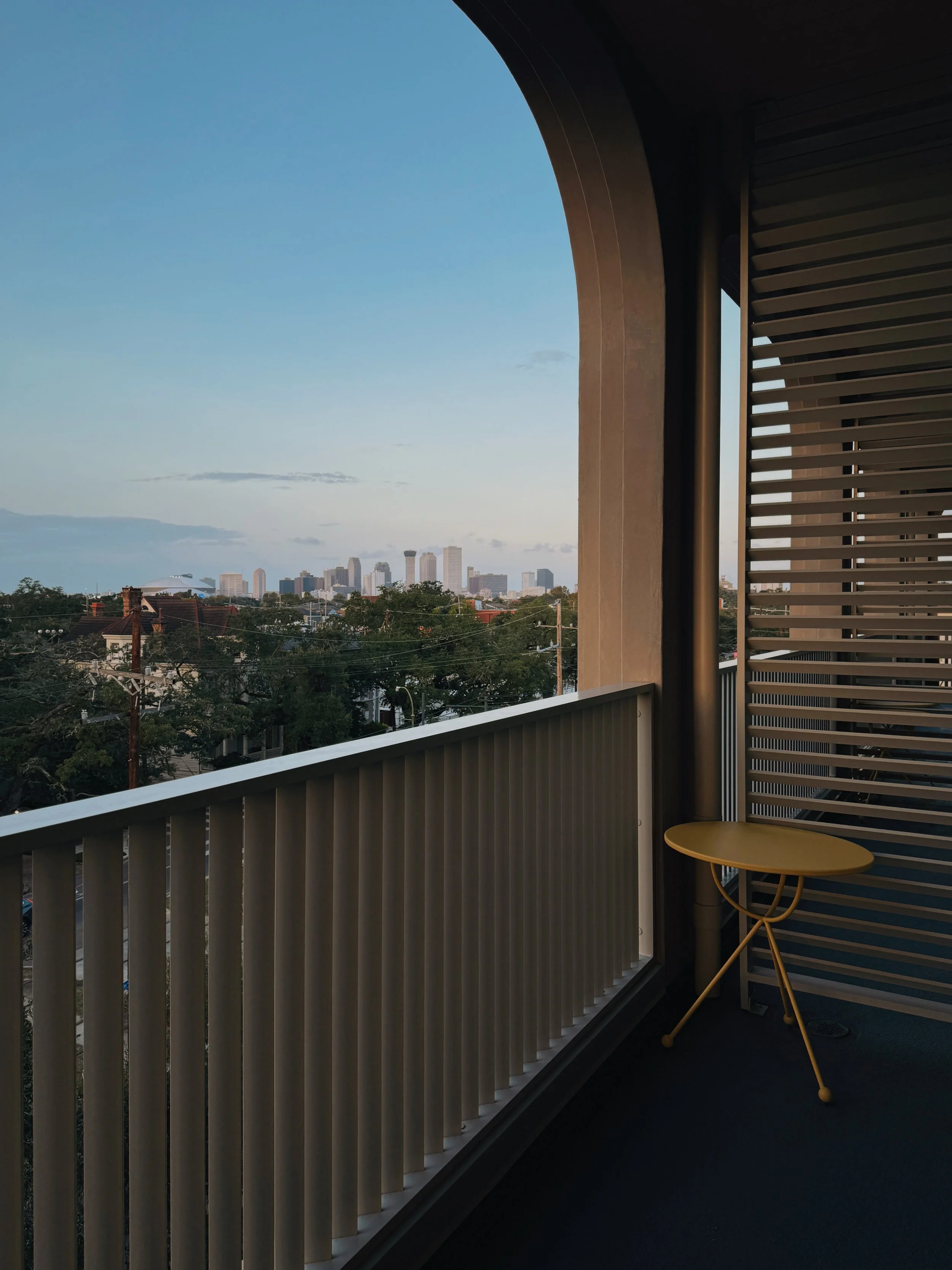 Private balcony at Hotel Henrietta New Orleans overlooking the city skyline photographed by architectural hotel photographer Natalia Moreno.