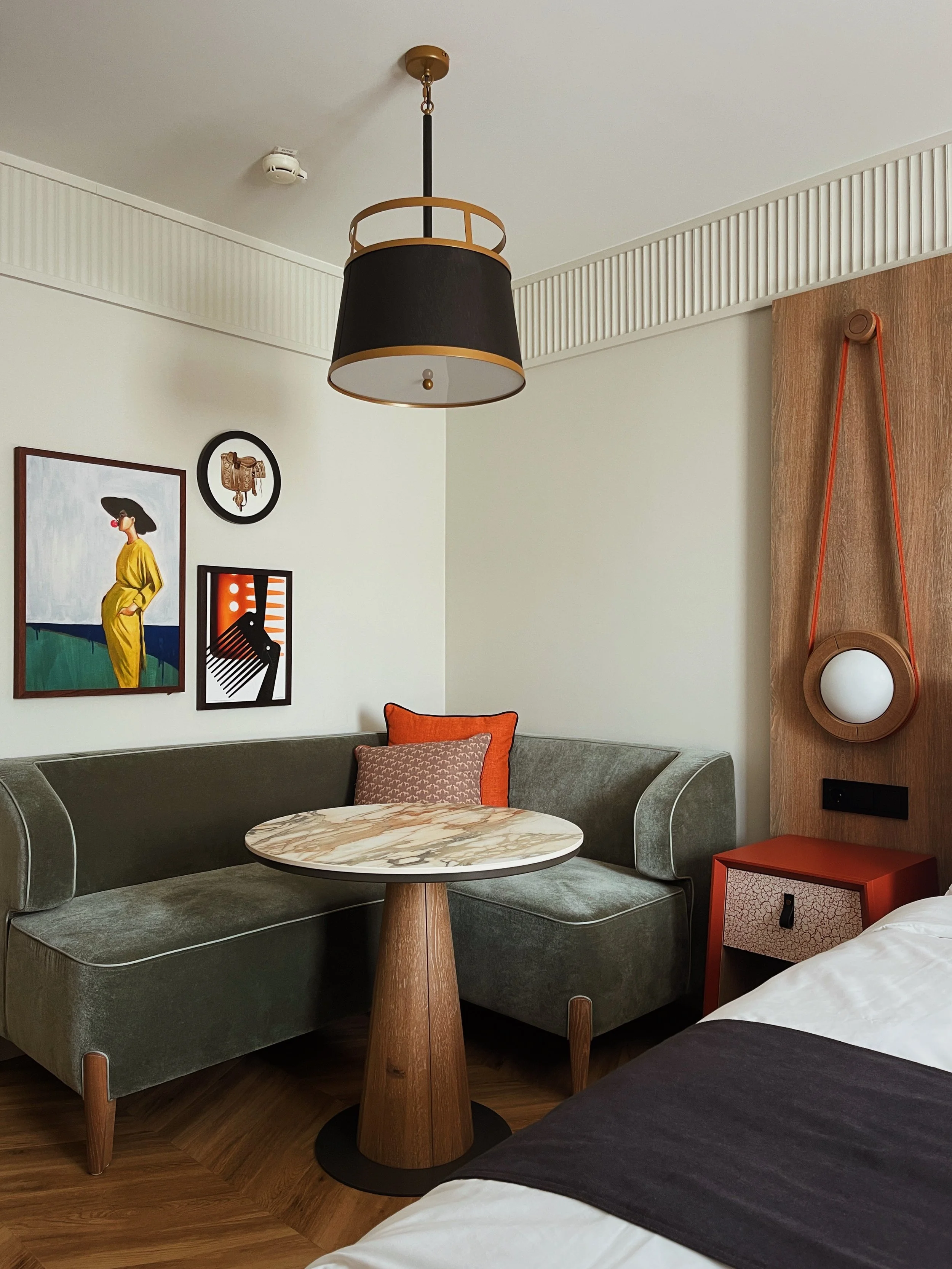 Guest room corner at Riding School Vienna luxury hotel with custom seating, warm wood accents, and contemporary architectural design