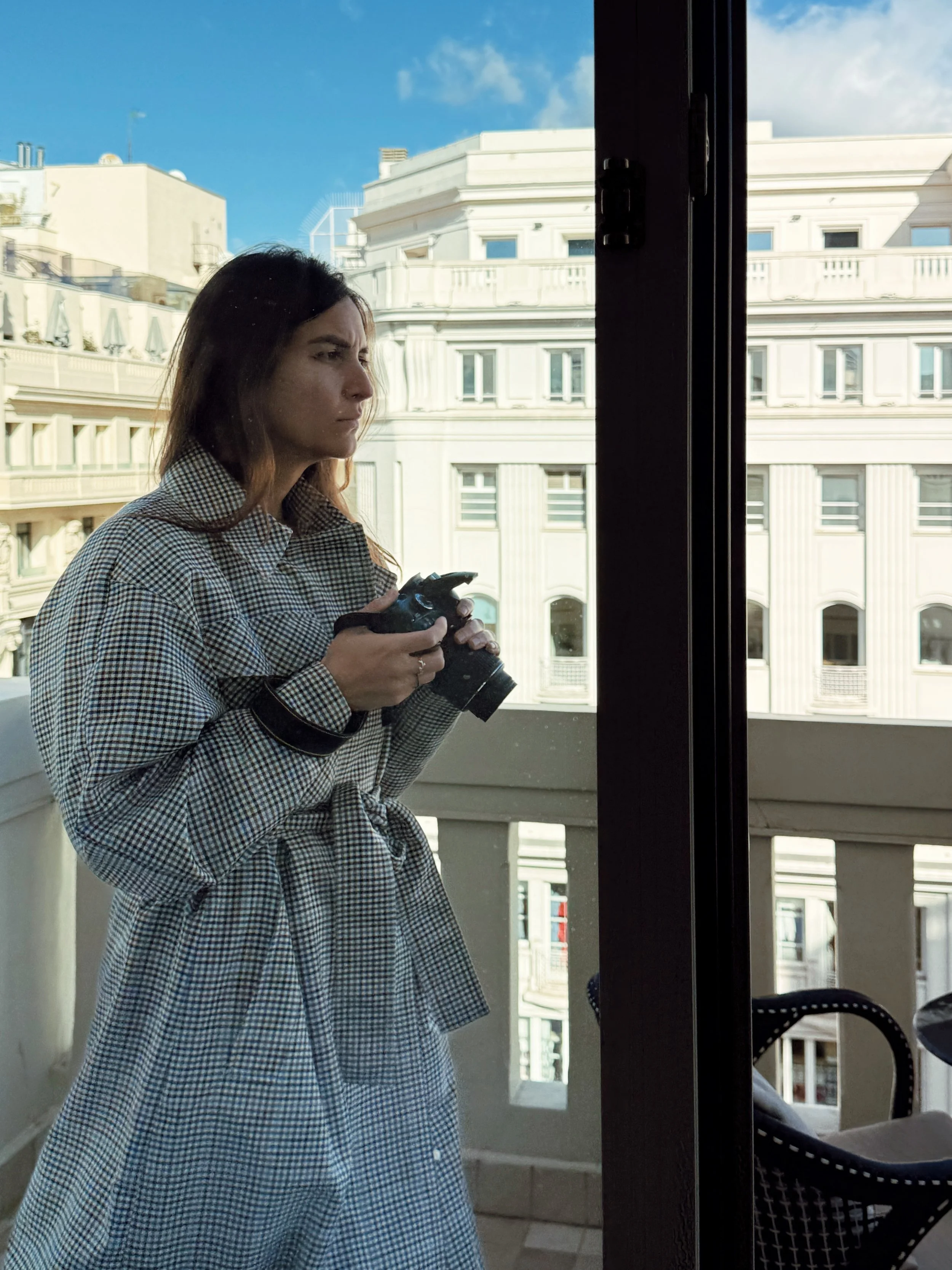 Photographer on balcony at Hyatt Centric Gran Vía Madrid overlooking historic city architecture.