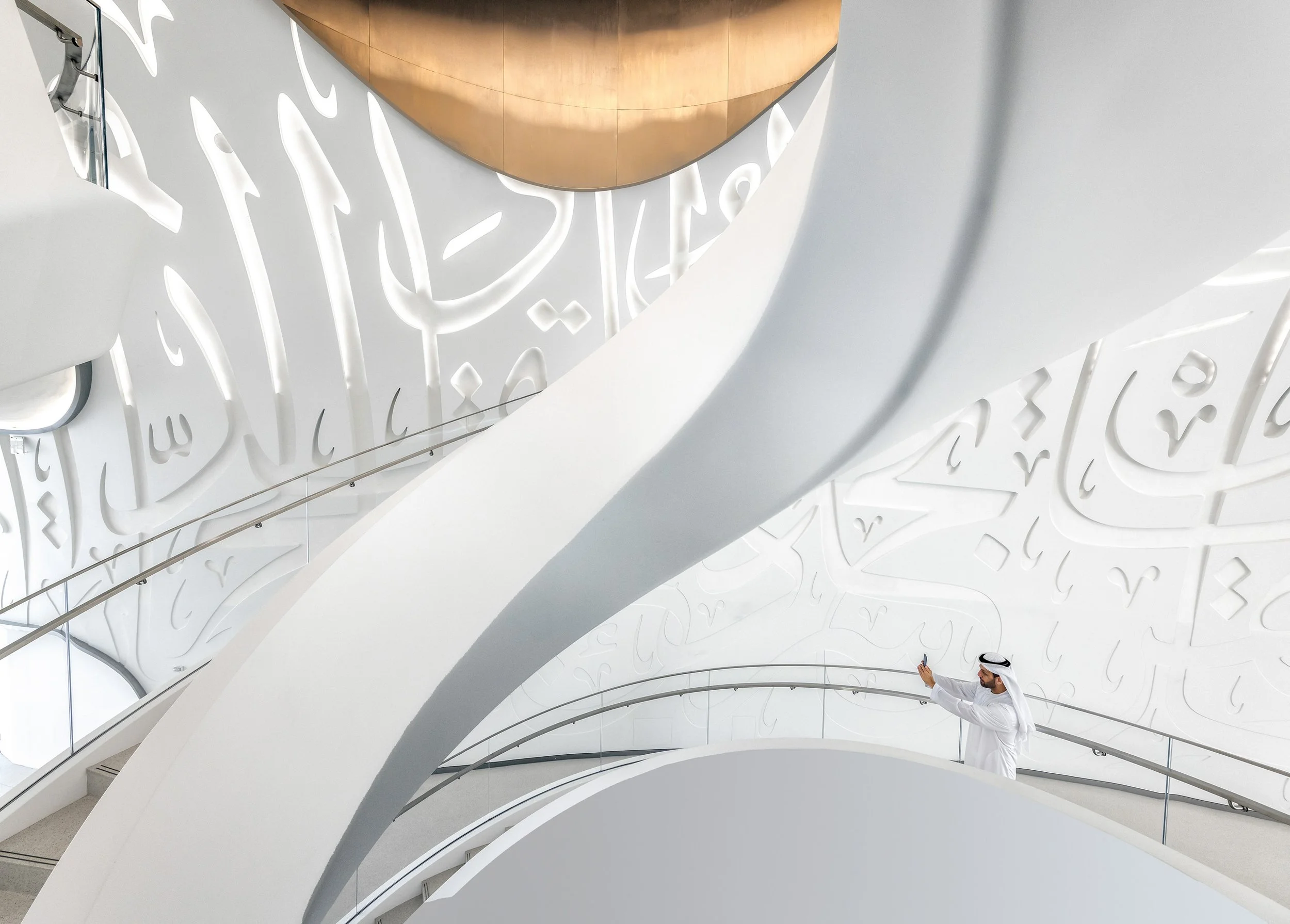 Museum of the Future white futuristic interior with curved staircase architecture and human figure for scale, Dubai — fine art architectural photograph by Ahmad Alnaji, SARAB Art Production