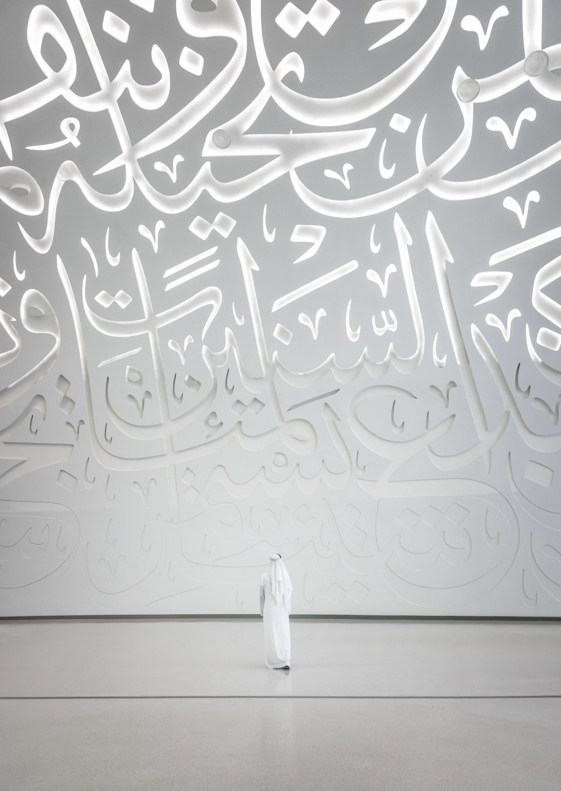 Museum of the Future white futuristic interior with an Emirati figure for scale showing architectural proportions, Dubai — fine art architectural photograph by Ahmad Alnaji, SARAB Art Production