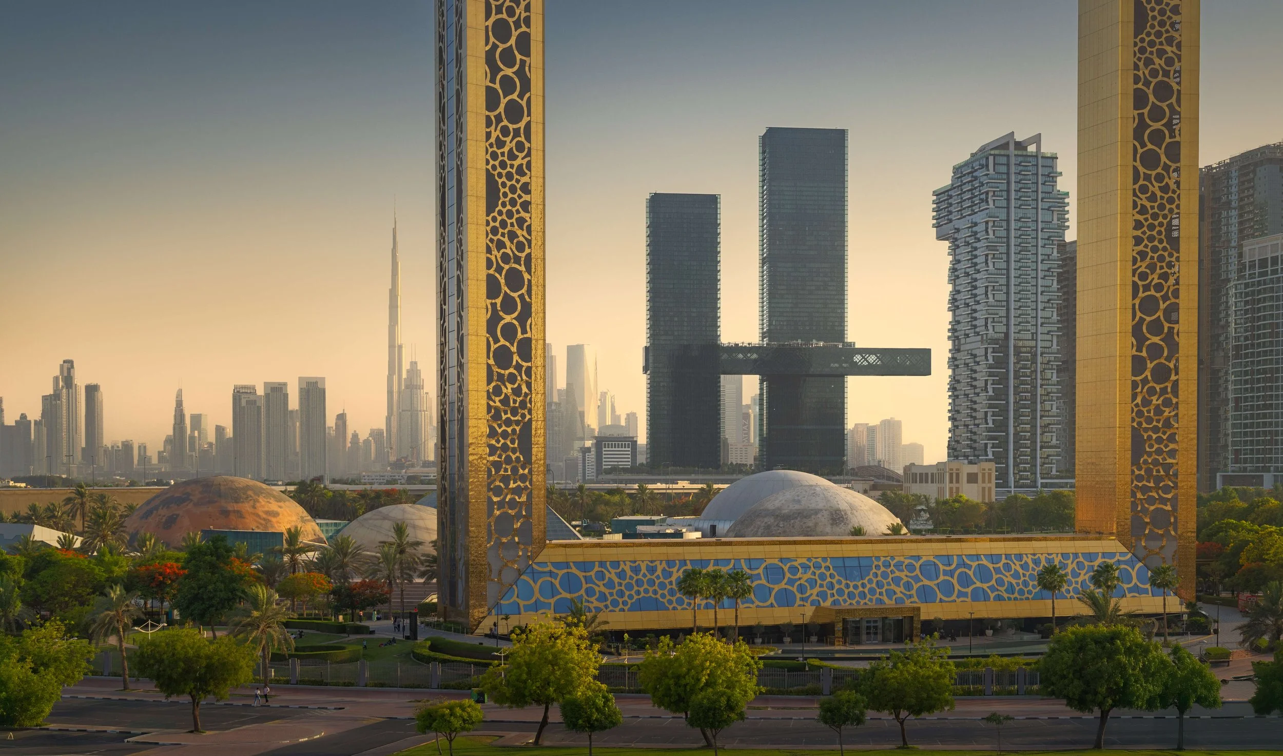 Close-up unique photo of Dubai Frame framing One Za'abeel, designed by Nikken Sekkei, and Dubai Skyline at golden hour— fine art architectural photograph by Ahmad Alnaji, SARAB Art Production

