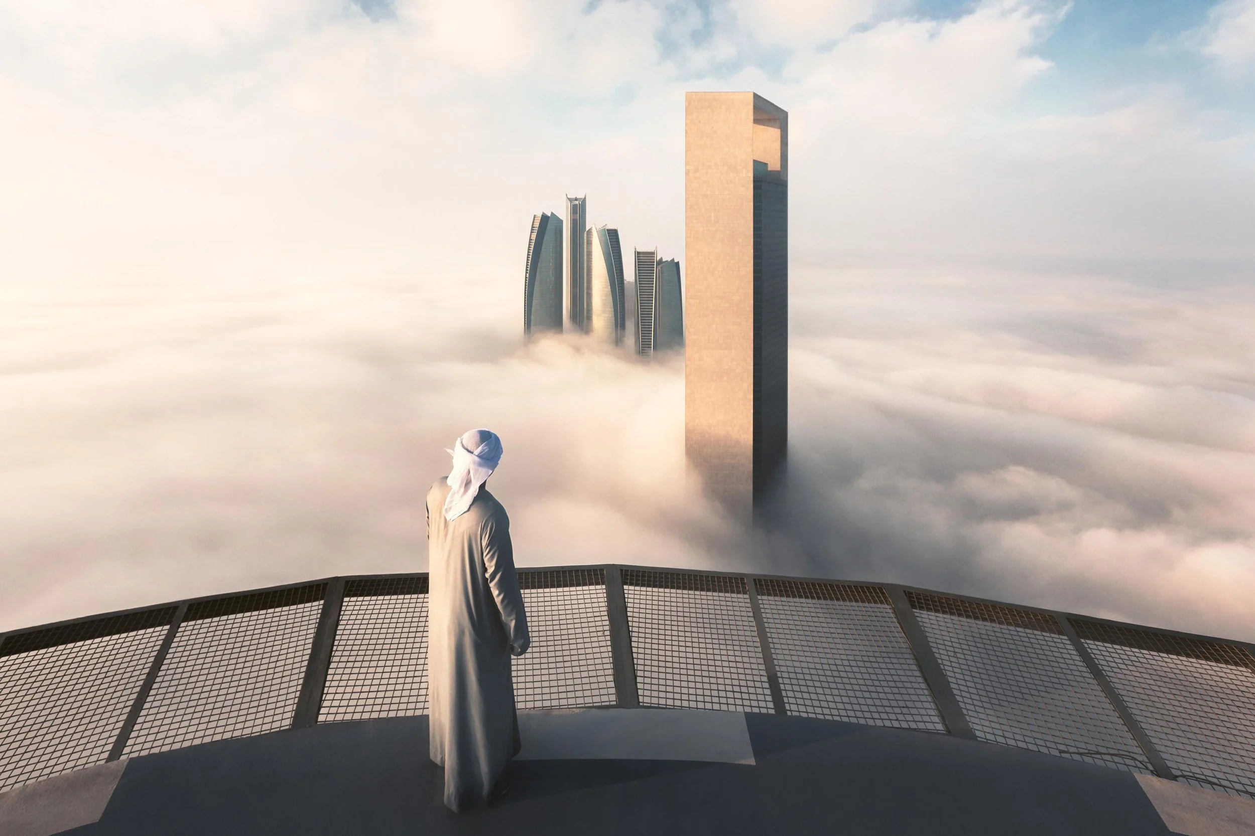 Abu Dhabi fog at sunrise showing Etihad Towers and Adnoc HQ with an Emirati man looking at the city skyline -photograph by khalid alhammadi, SARAB Art Production