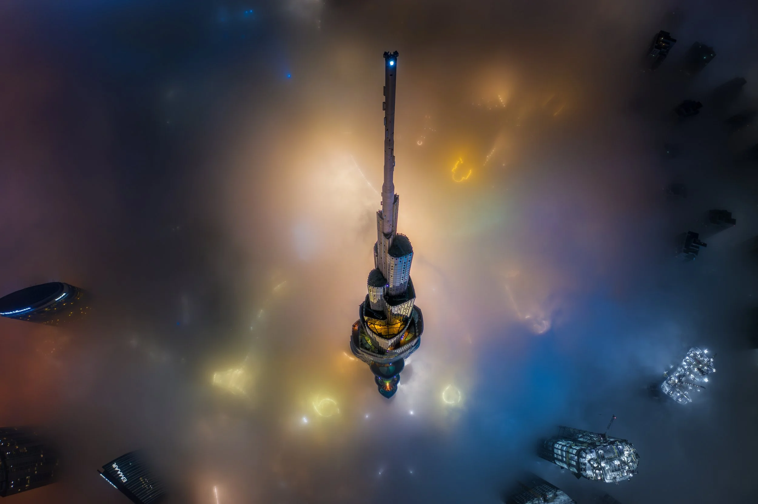 Burj Khalifa designed by SOM in a rare aerial view at night above the fog, Dubai — fine art cityscape photograph by Ahmad Alnaji, SARAB Art Production