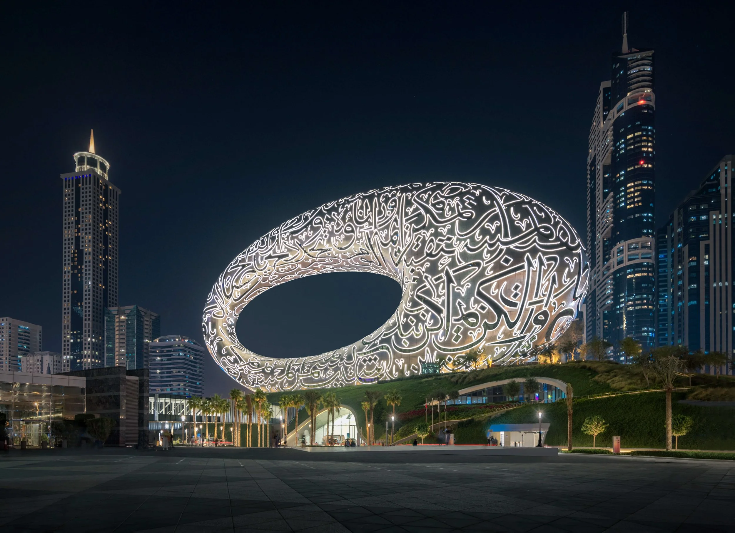 Museum of the Future white illuminated at night with Dubai city skyline — fine art architectural photograph by Ahmad Alnaji, SARAB Art Production