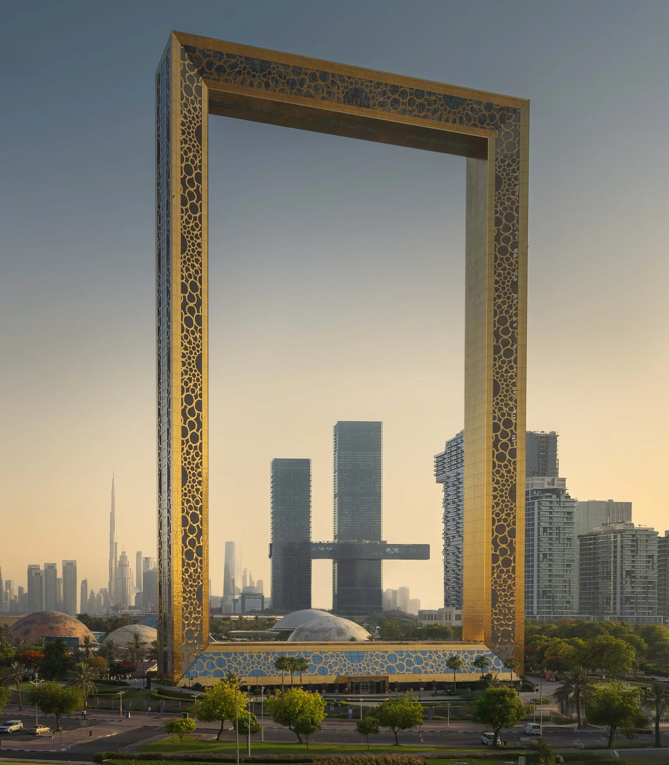 Creative framing in architectural photography: One Za'abeel and Dubai Skyline viewed through the Dubai Frame (designed by Fernando Donis) at Sunset. A unique perspective shot by Ahmad Alnaji, sarab