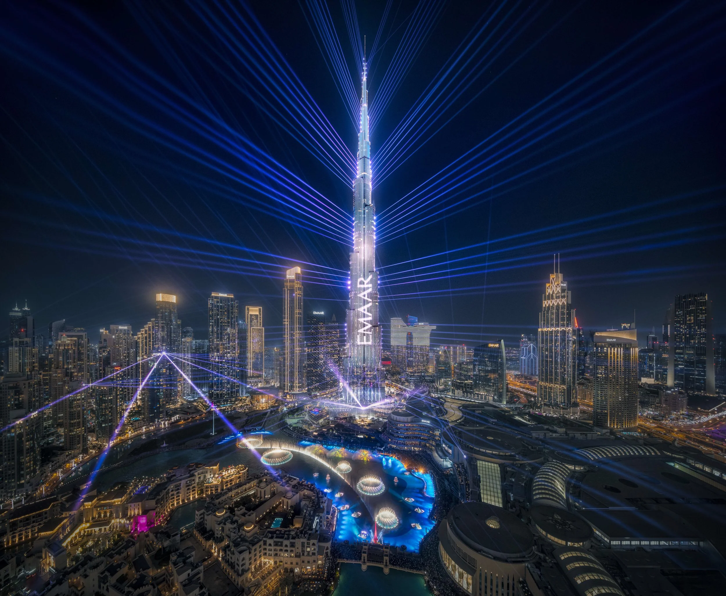Burj Khalifa light and laser show by Knvat illuminating Dubai night sky — fine art architectural photograph by Ahmad Alnaji, SARAB Art Production