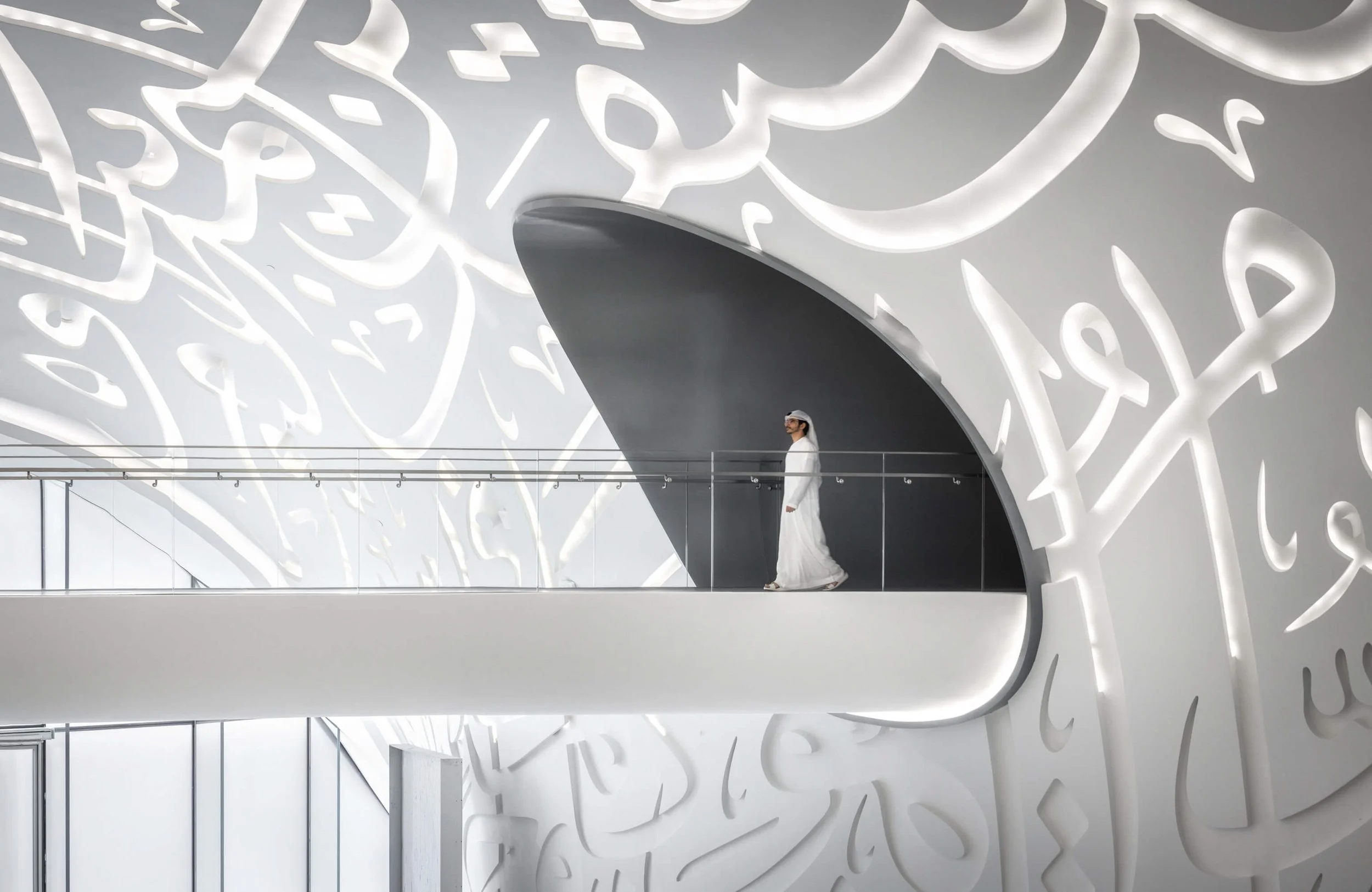 Museum of the Future white interior space with Arabic calligraphy and lone figure for scale, Dubai — fine art architectural photograph by Ahmad Alnaji, SARAB Art Production