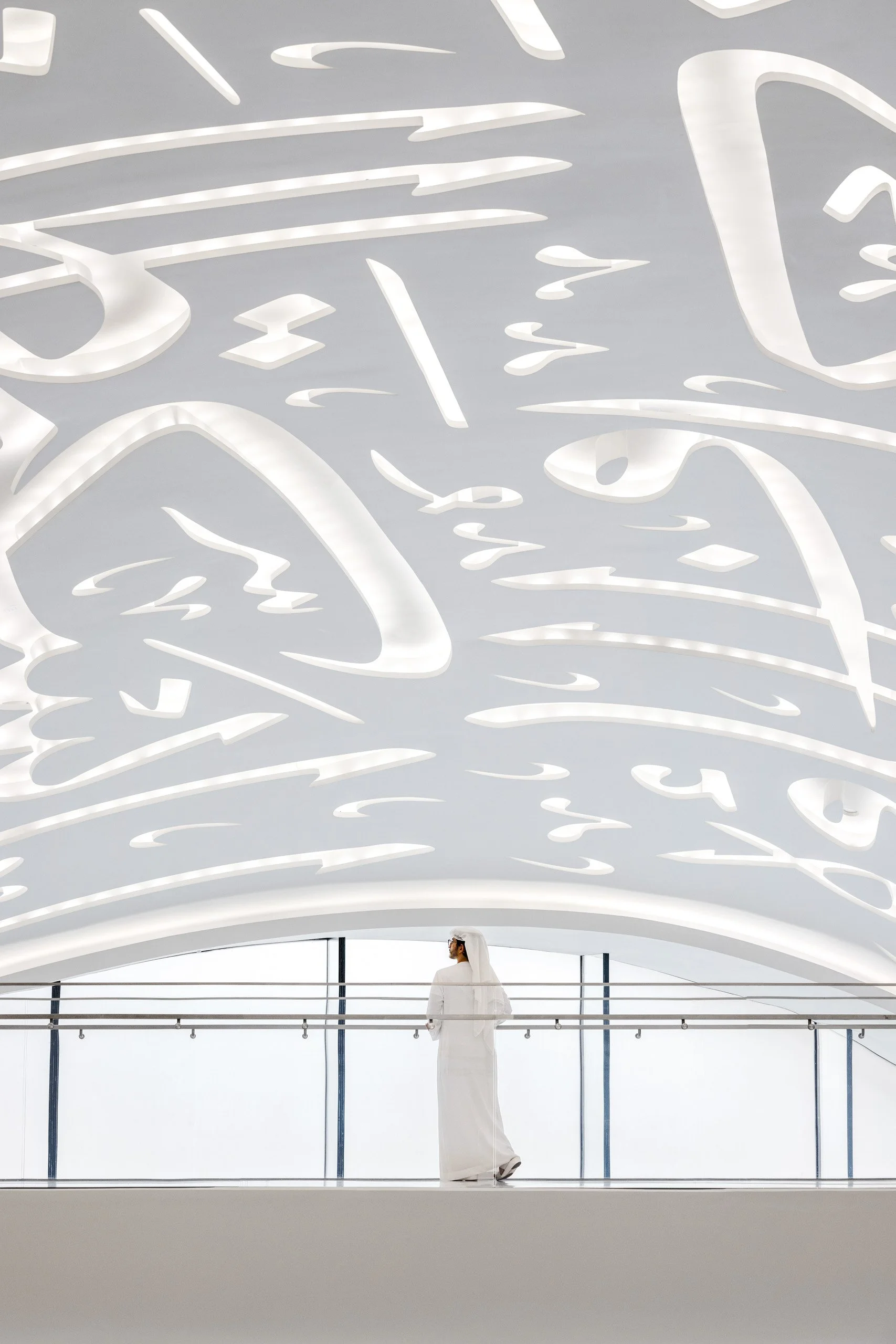 Museum of the Future white interior space with Arabic calligraphy and lone figure for scale, Dubai — fine art architectural photograph by Ahmad Alnaji, SARAB Art Production