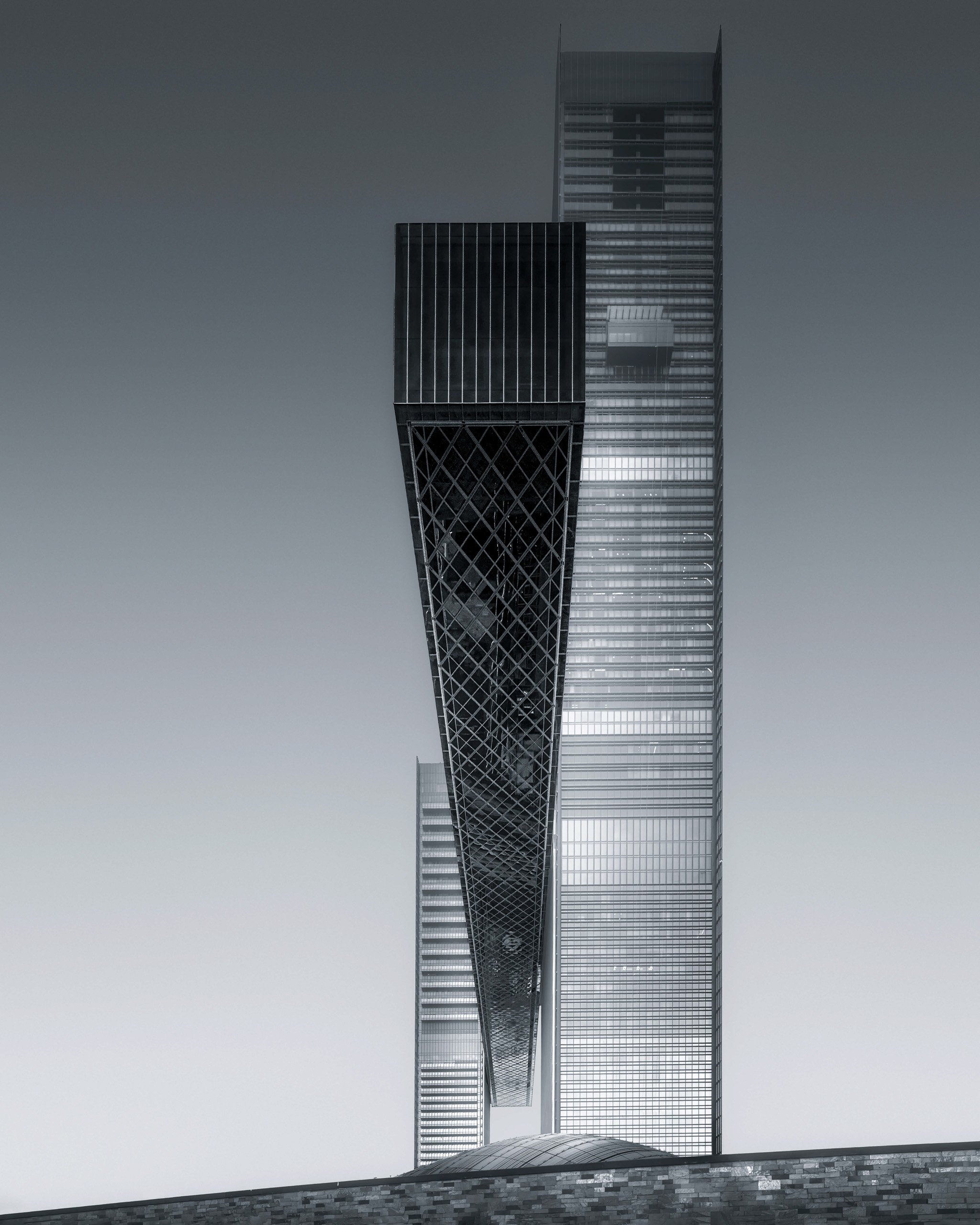 Abstract monochromatic architectural photography focusing on the vertical geometry and the intersecting Link of One Za'abeel. A minimalist study by Ahmad Alnaji