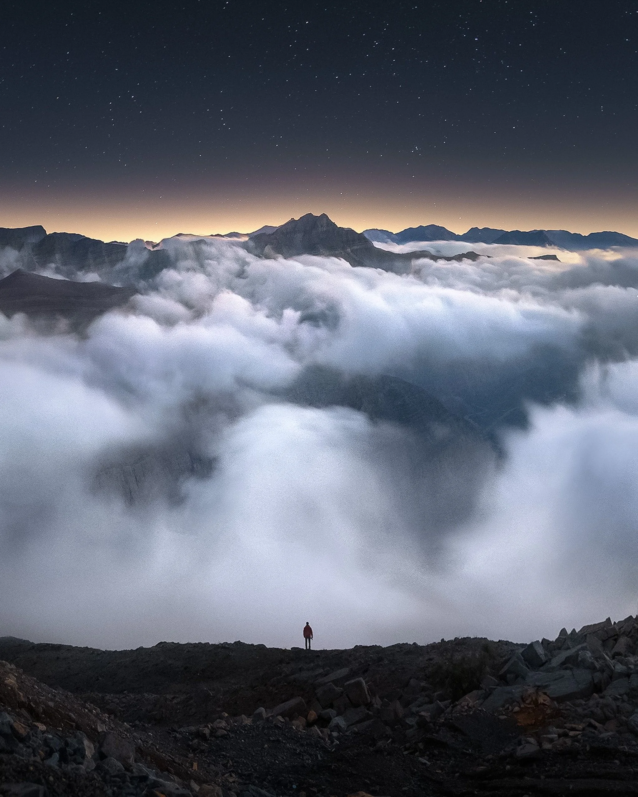 hiker-above-clouds-starry-night-rak-mountains-uae-sarab.jpg