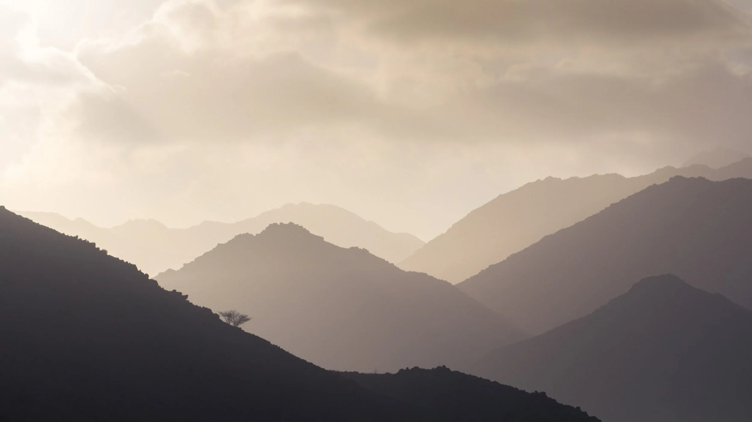layered-mountain-silhouettes-hazy-sky-uae-sarab.jpg