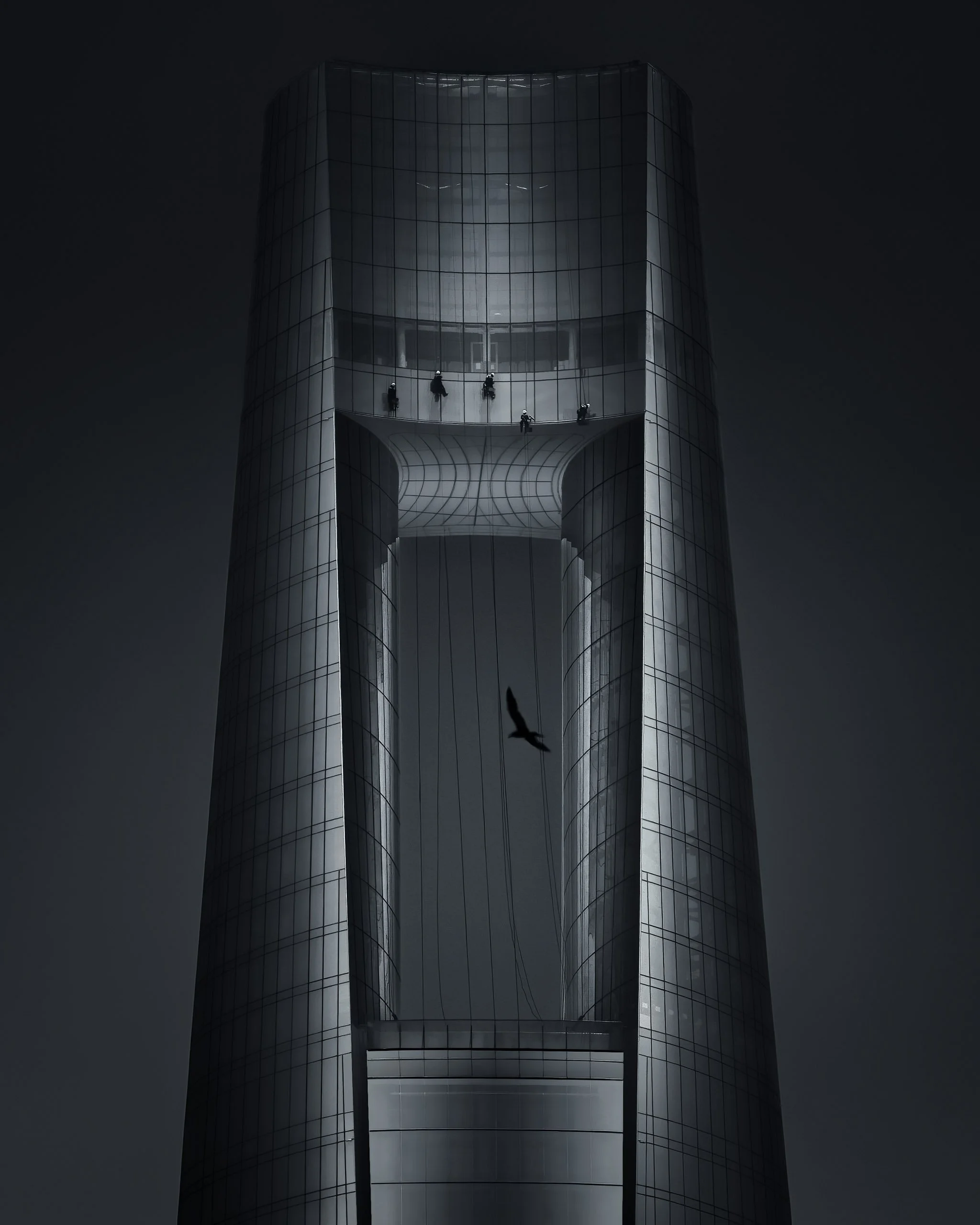 Window cleaners on the glass above the aperture of Ciel Dubai Marina, a bird crossing the void below.