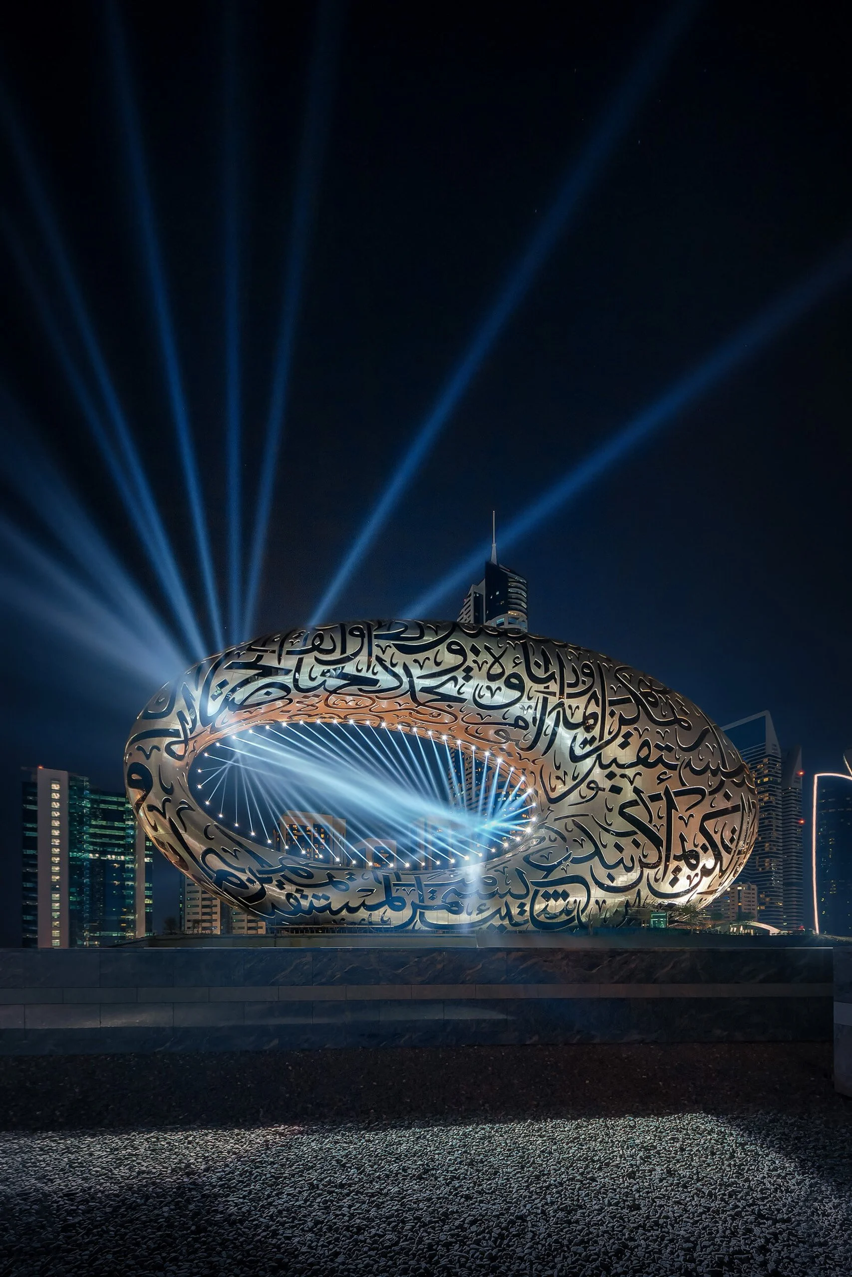 Museum of the Future dramatic searchlight beams shooting into the Dubai sky — fine art architectural photograph by Ahmad Alnaji, SARAB Art Production
