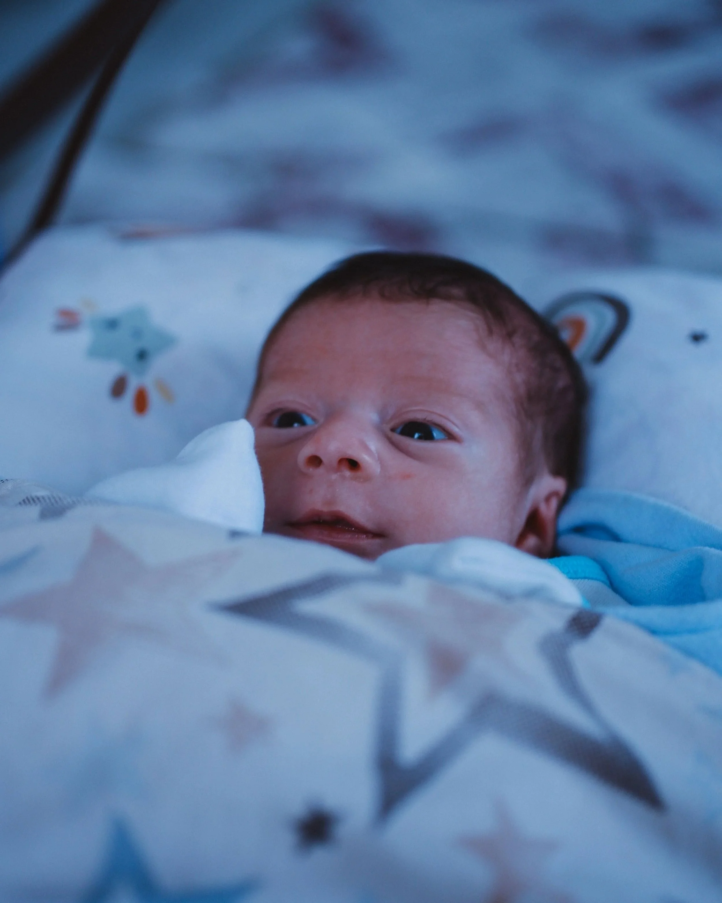 A wide-awake baby.  A postpartum doula takes care of the baby overnight while the parents sleep.