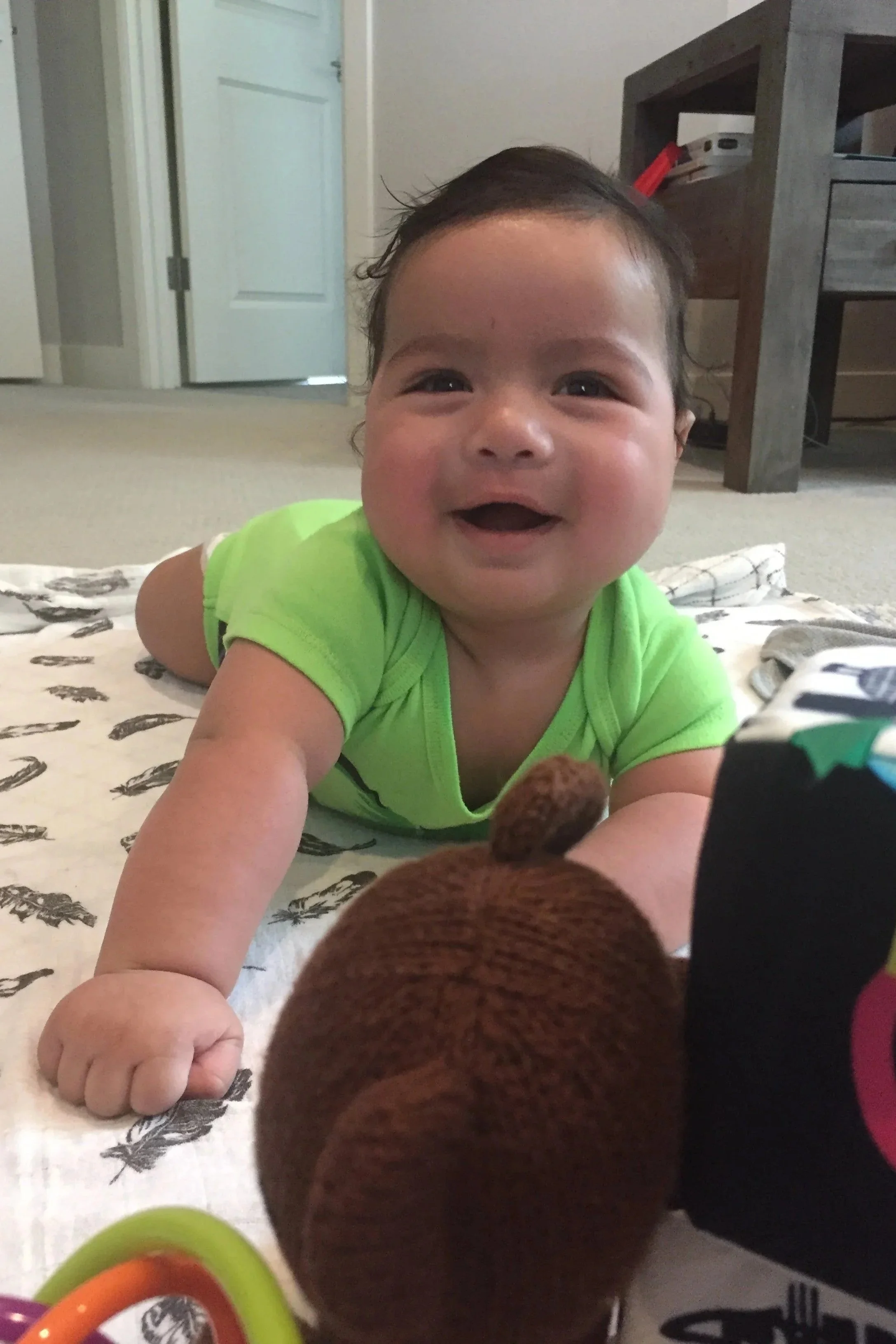 A postpartum doula supervising a newborn baby's tummy time.