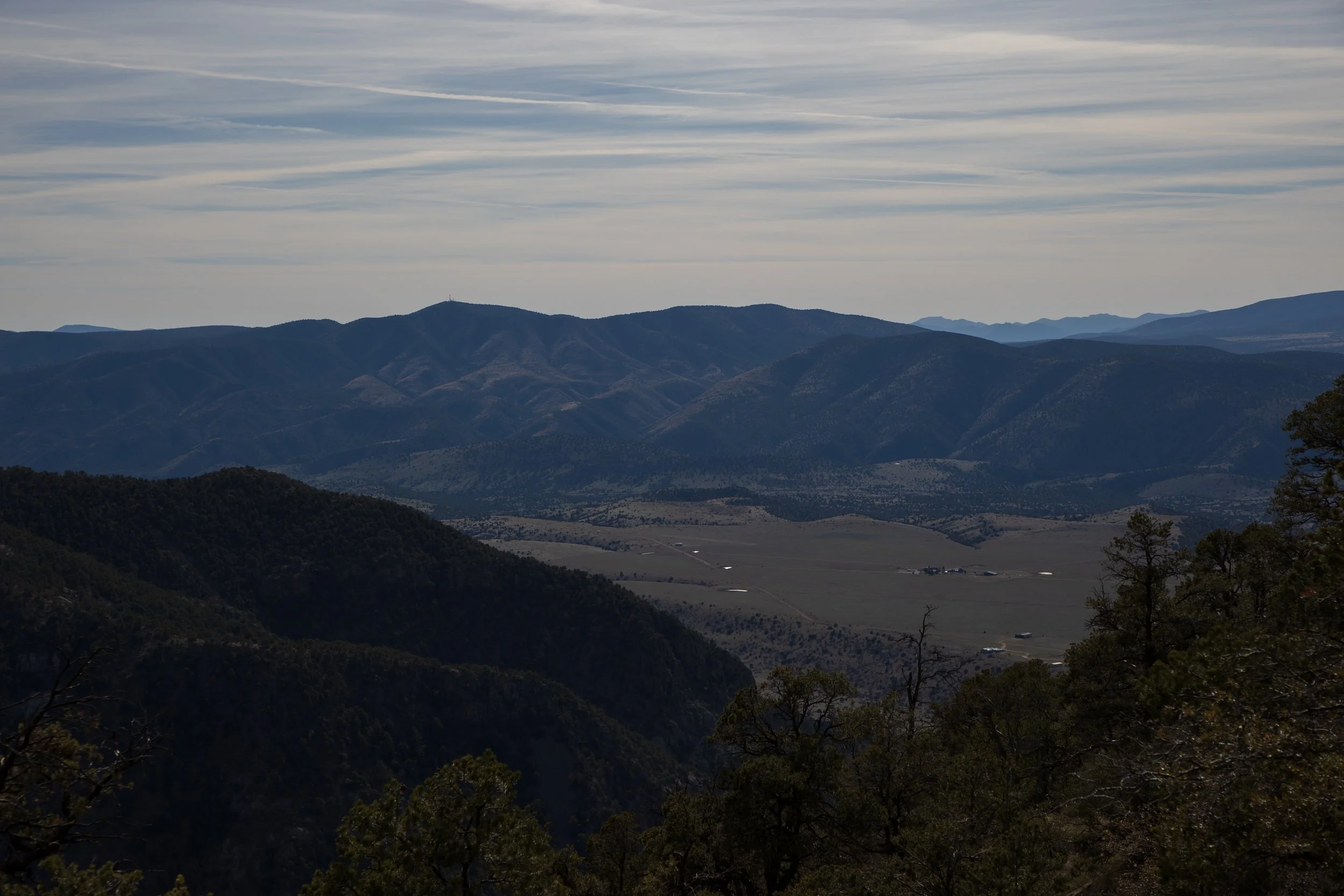 Mountain landscape with rolling hills and scattered trees