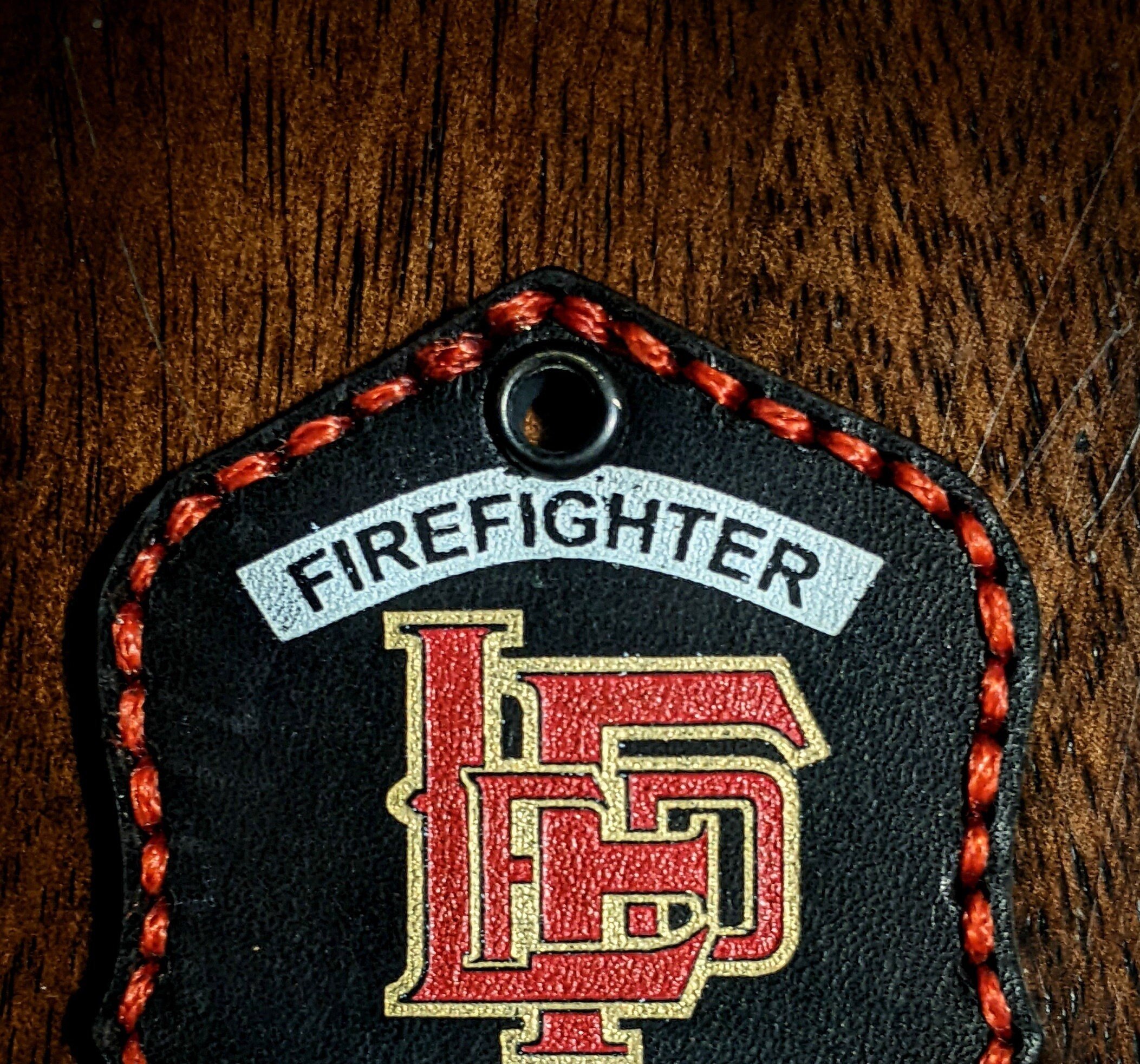 Custom Black Leather Firefighter helmet shield keychain.