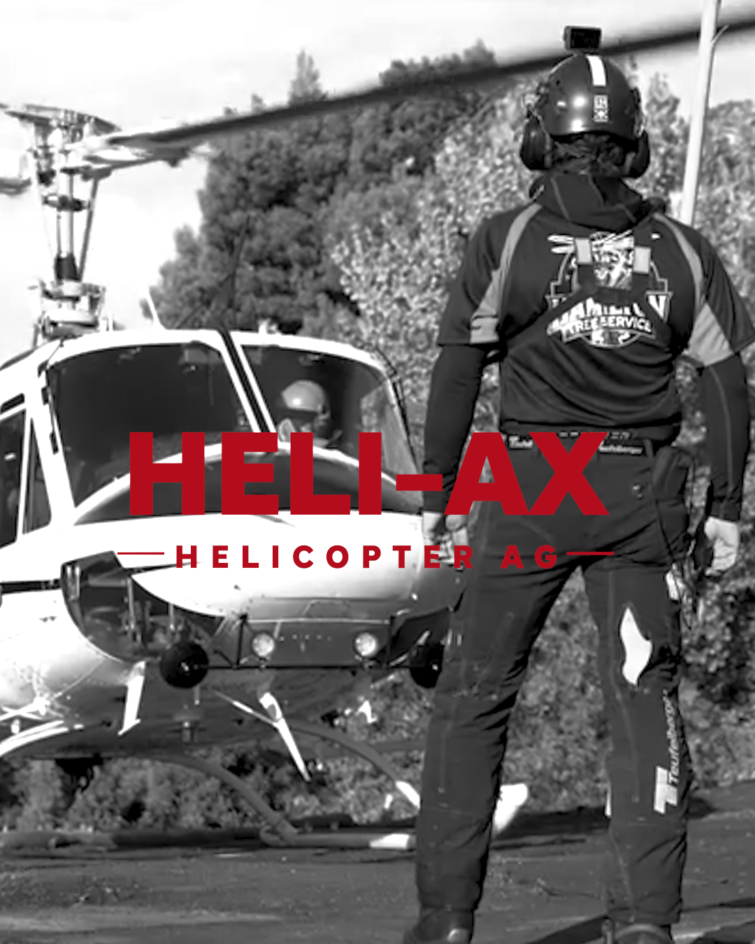 Black and white photo of a helicopter with personnel standing nearby. The image is overlaid with the text 'HELL-AX HELICOPTER AG' in bold red letters.