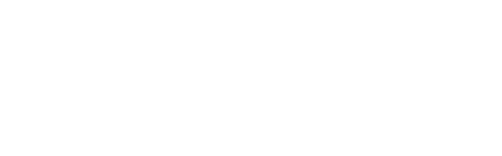 A black computer keyboard on a desk with a white background.