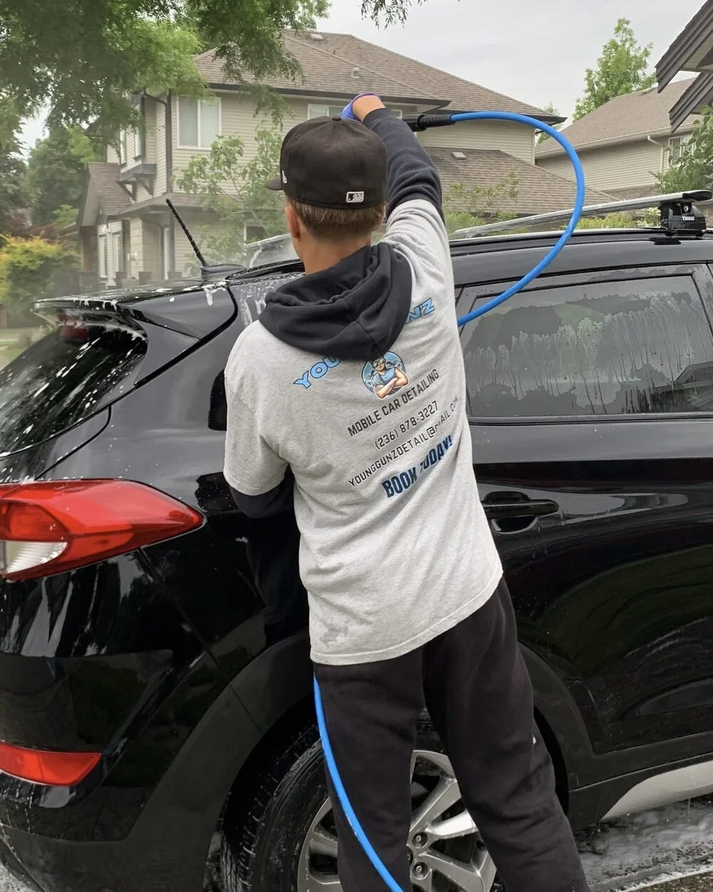 Logan detailing a vehicle, founder of Young Gun'z