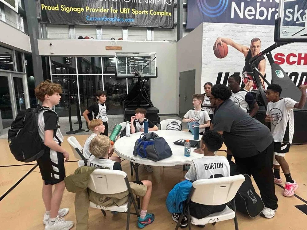 NBA Team sits around a table in between tournament games