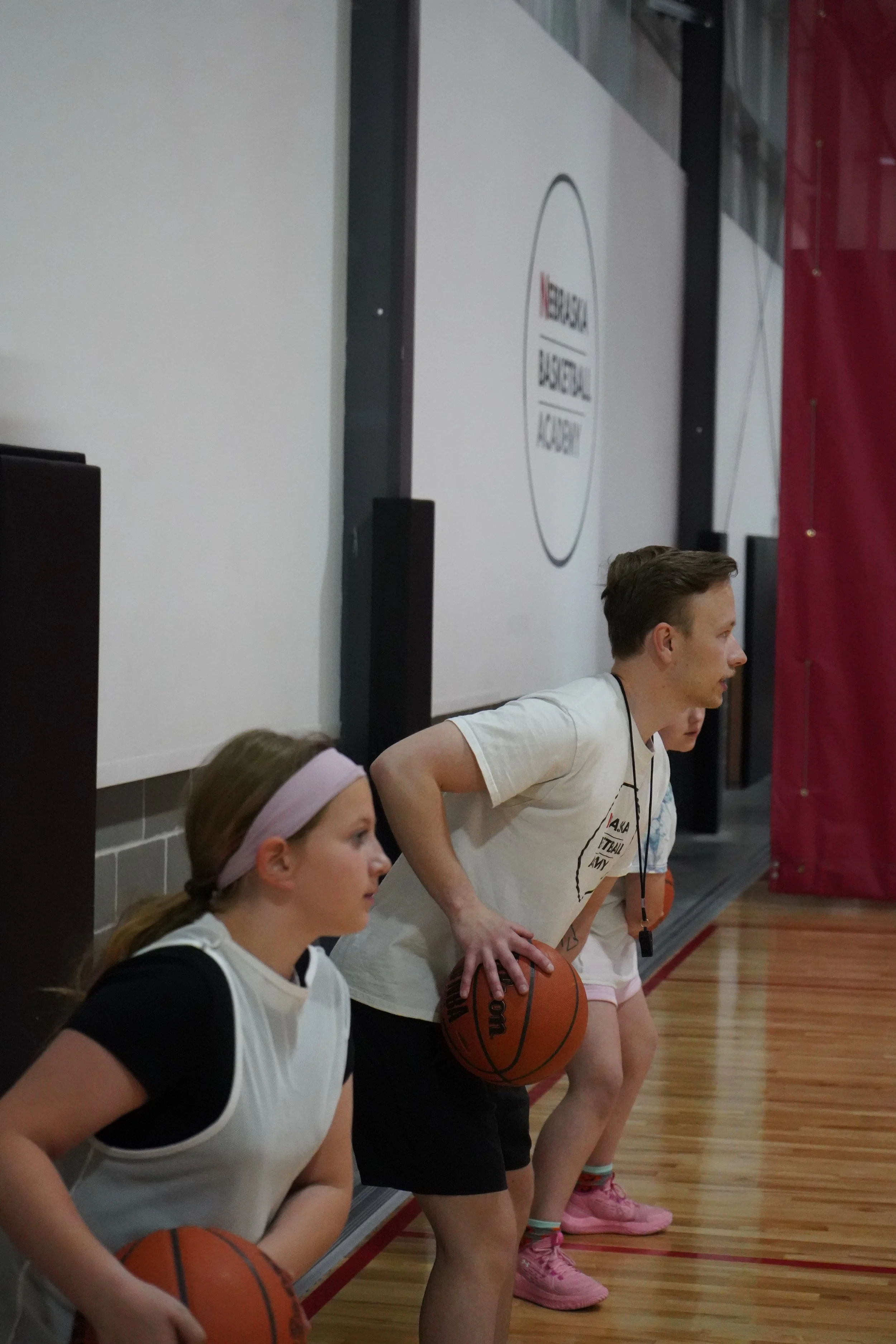Coach in Triple Threat position coaching a girl