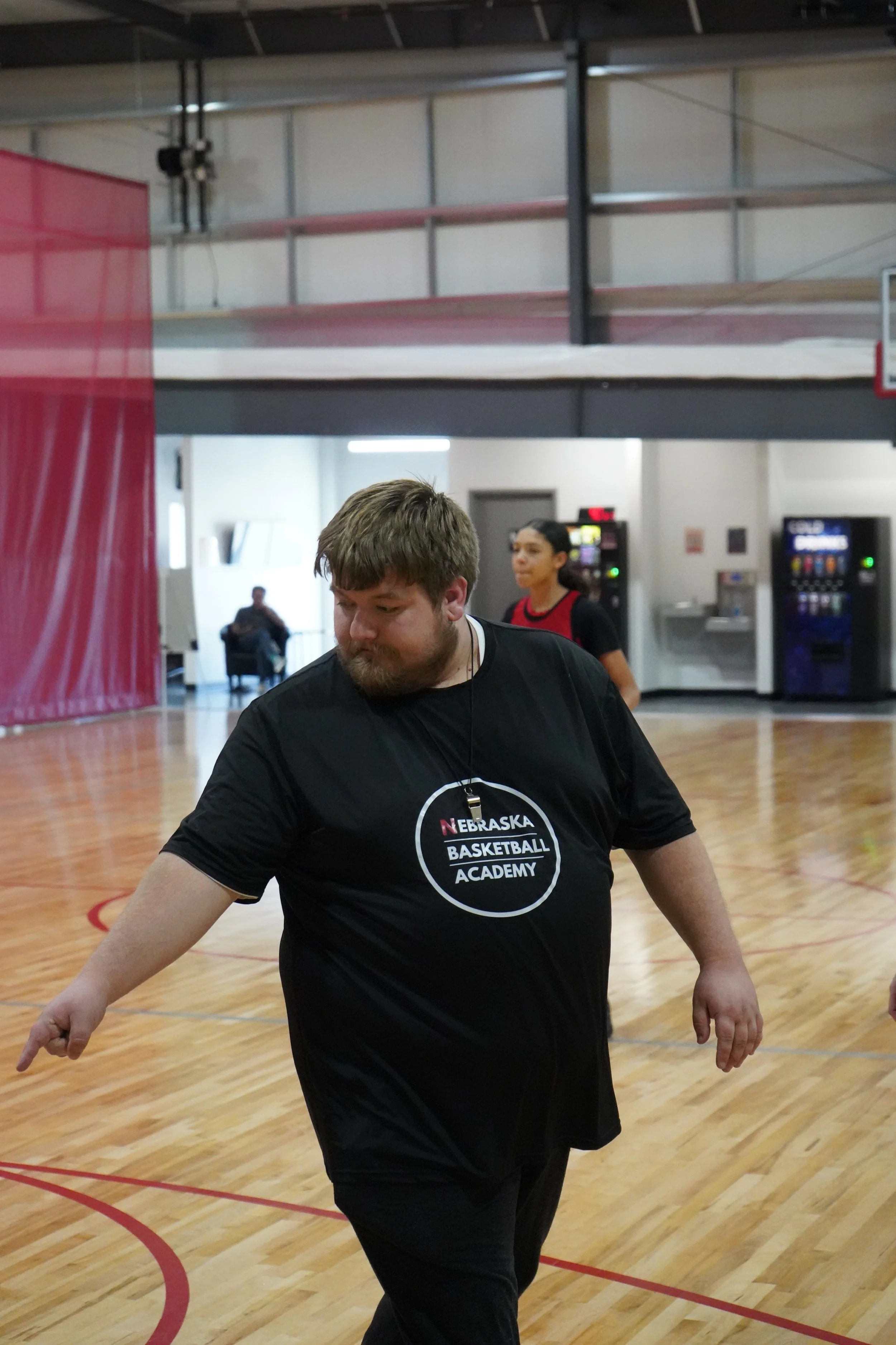 Coach wearing Nebraska Basketball Academy shirt coaching