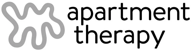 Logo for digital platform 'apartment therapy' featuring a stylized abstract shape in gray next to black text reading 'apartment therapy'.