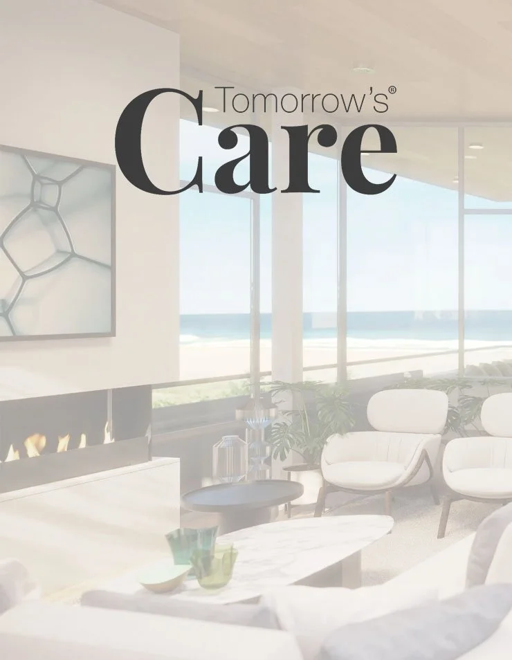 Magazine titled 'Tomorrow's Care' for October/November 2025 on a table in a bright living room with a fire and plants.