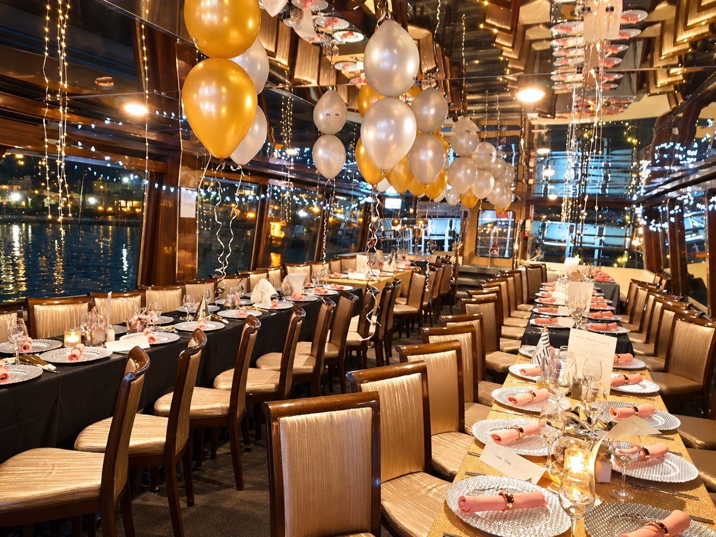 Yoho Cruises dining room set for a celebration with gold and silver balloons
