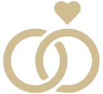Two interlocked wedding rings with a heart-shaped accent above them, on a beige background.