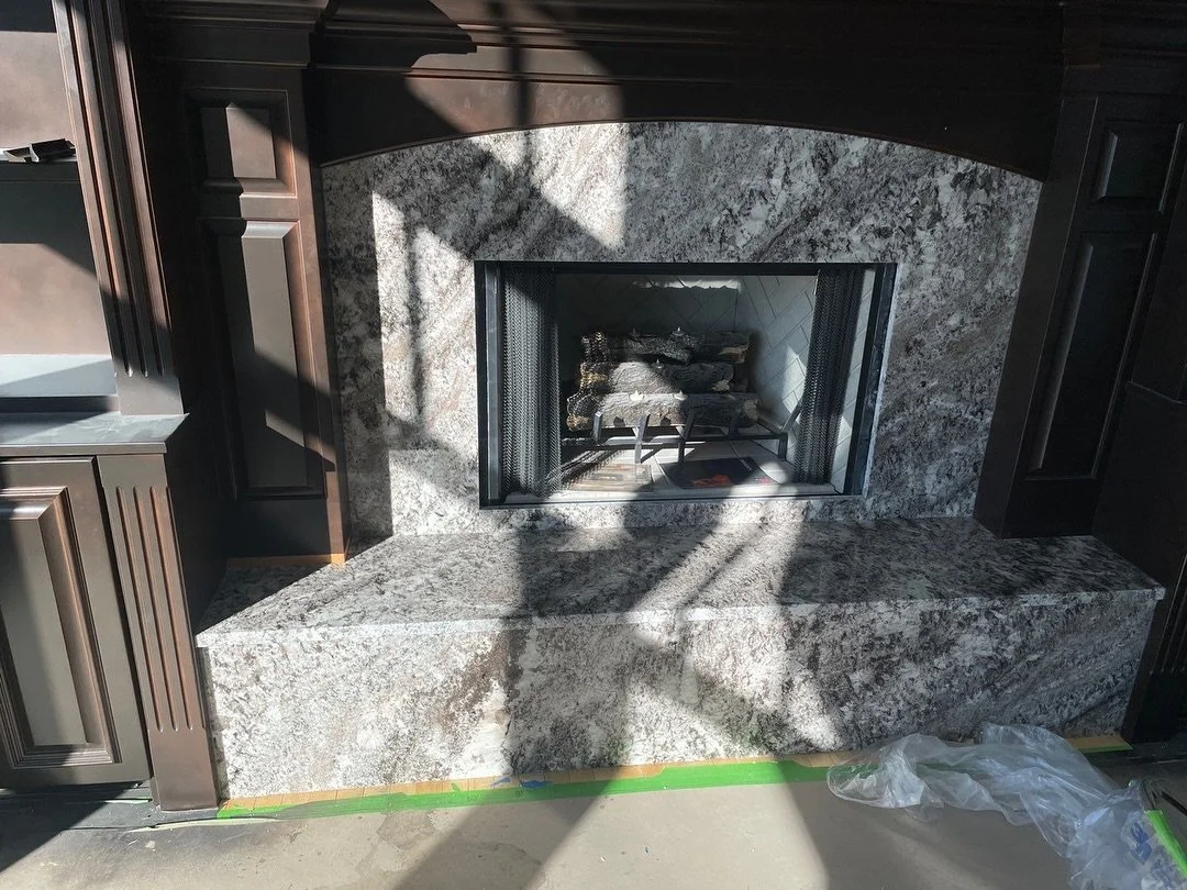 Have you ever thought about adding granite to your fireplace? 

Look at the transformation &mdash; swipe to see the before ➡️

We took this traditional built-in fireplace surround and gave it a dramatic upgrade with a rich espresso-stained millwork a