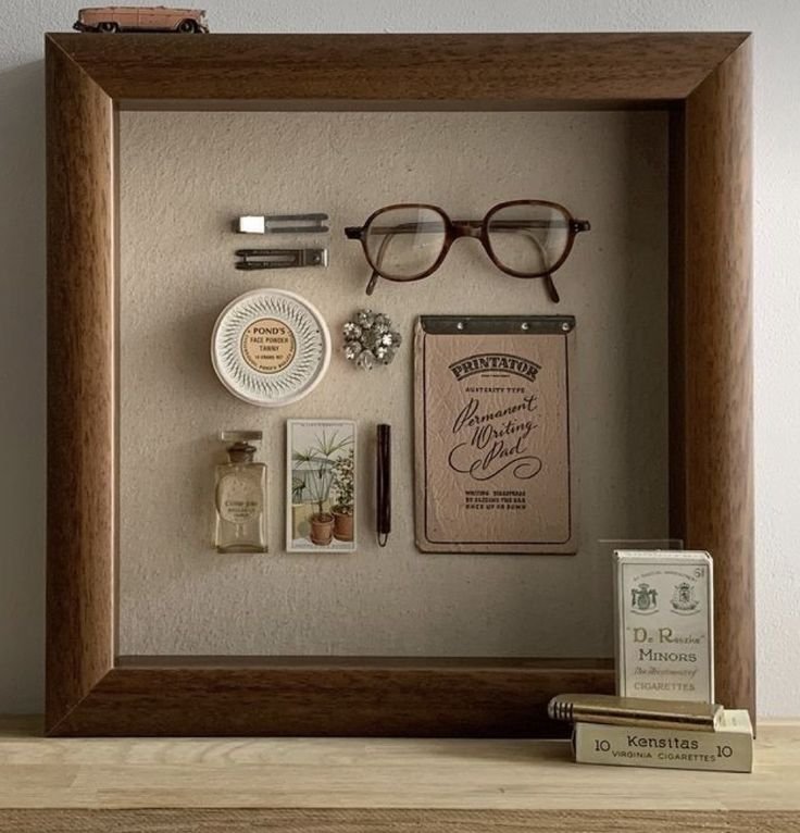 Heirloom shadowbox of personal items displayed on a shelf.
