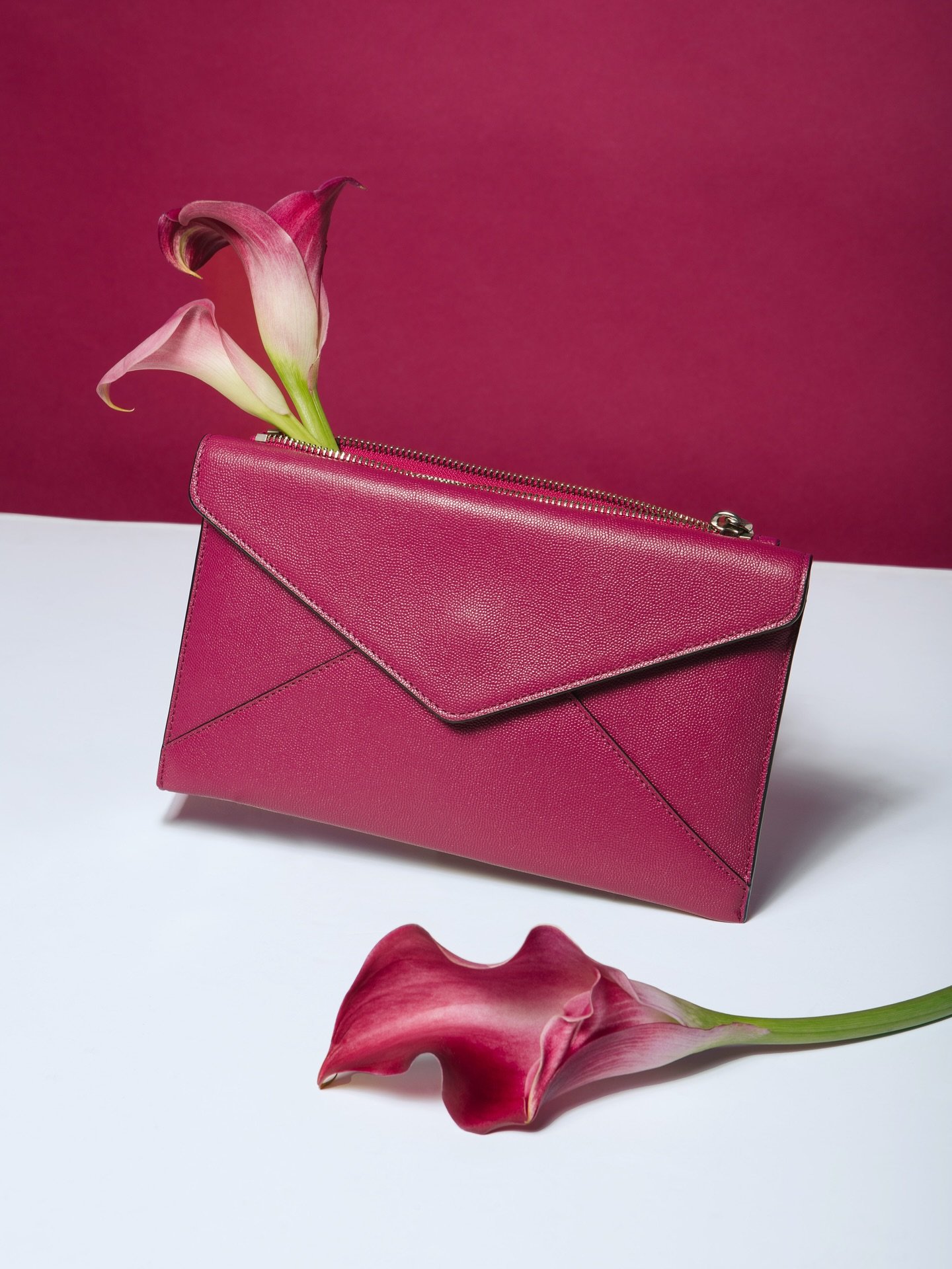 Help me decide... all white background or extra cranberry color pop?

Purse: @rebeccaminkoff 
Studio: @studio.m.nyc