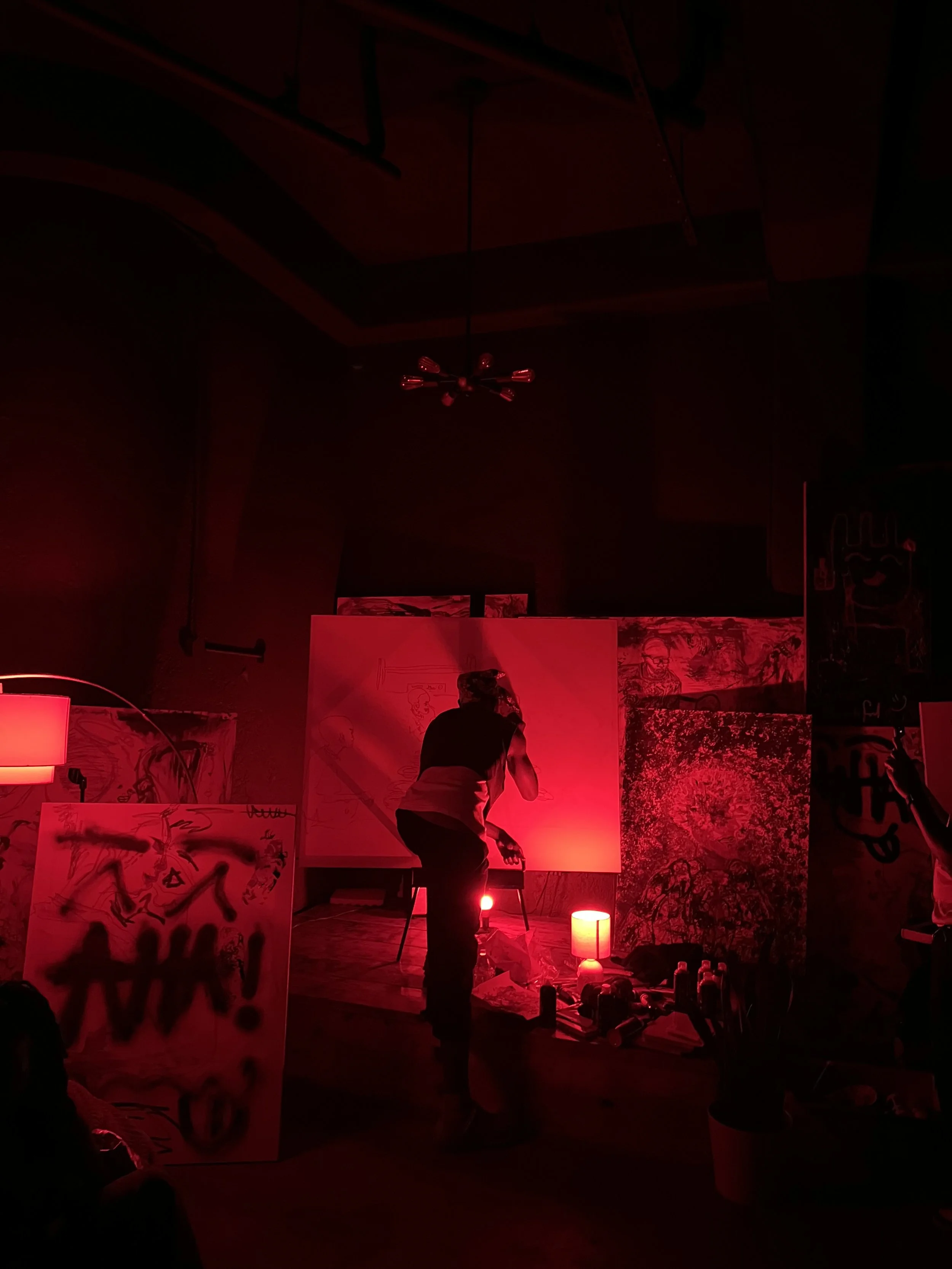 Dozye painting live under the red light at The Red Room: Volume 2.