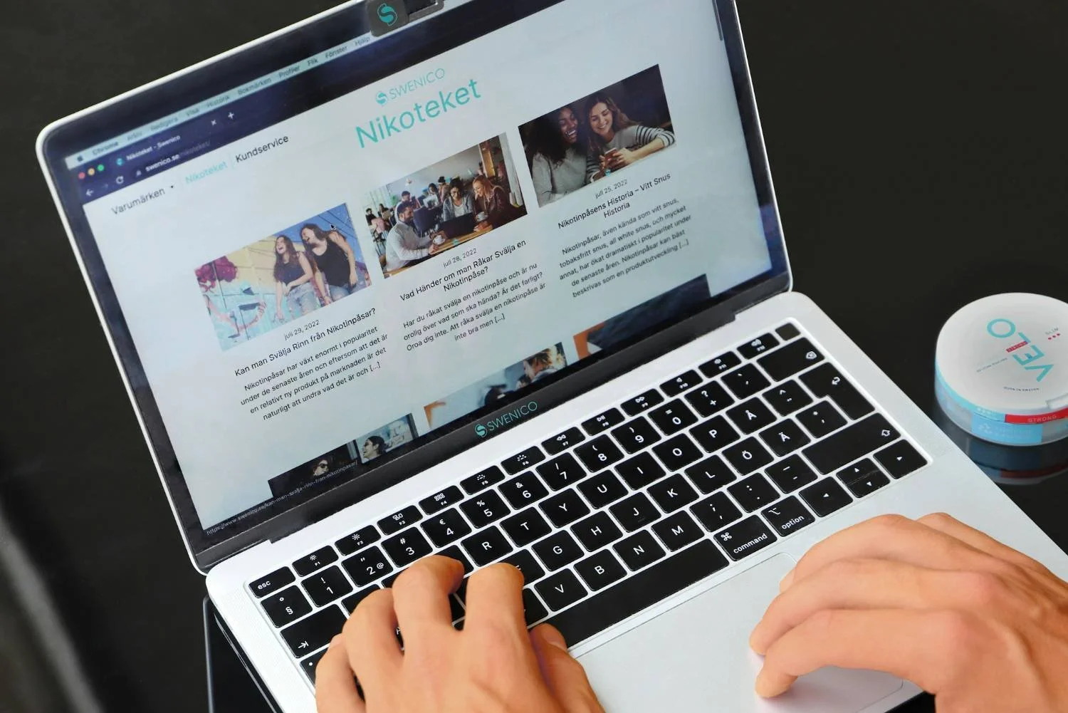 Man's hands typing on laptop displaying a content blog site, representing self-researching behavior before seeking anxiety counseling in Mooresville, NC.